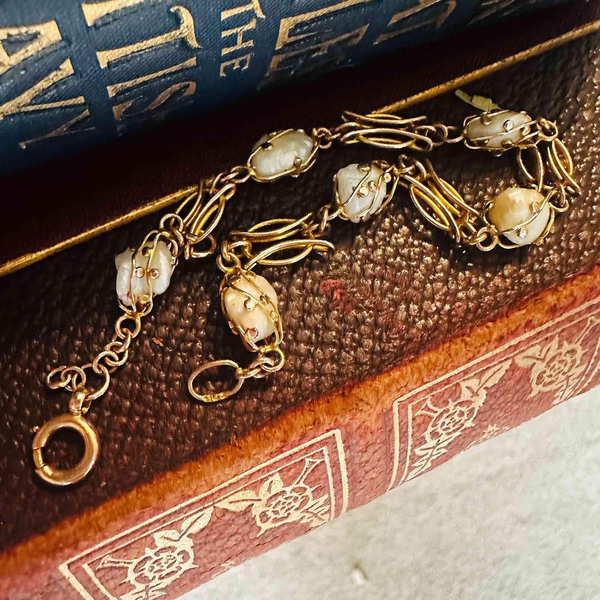 Art nouveau 9k rose gold cage pearl bracelet on antique books