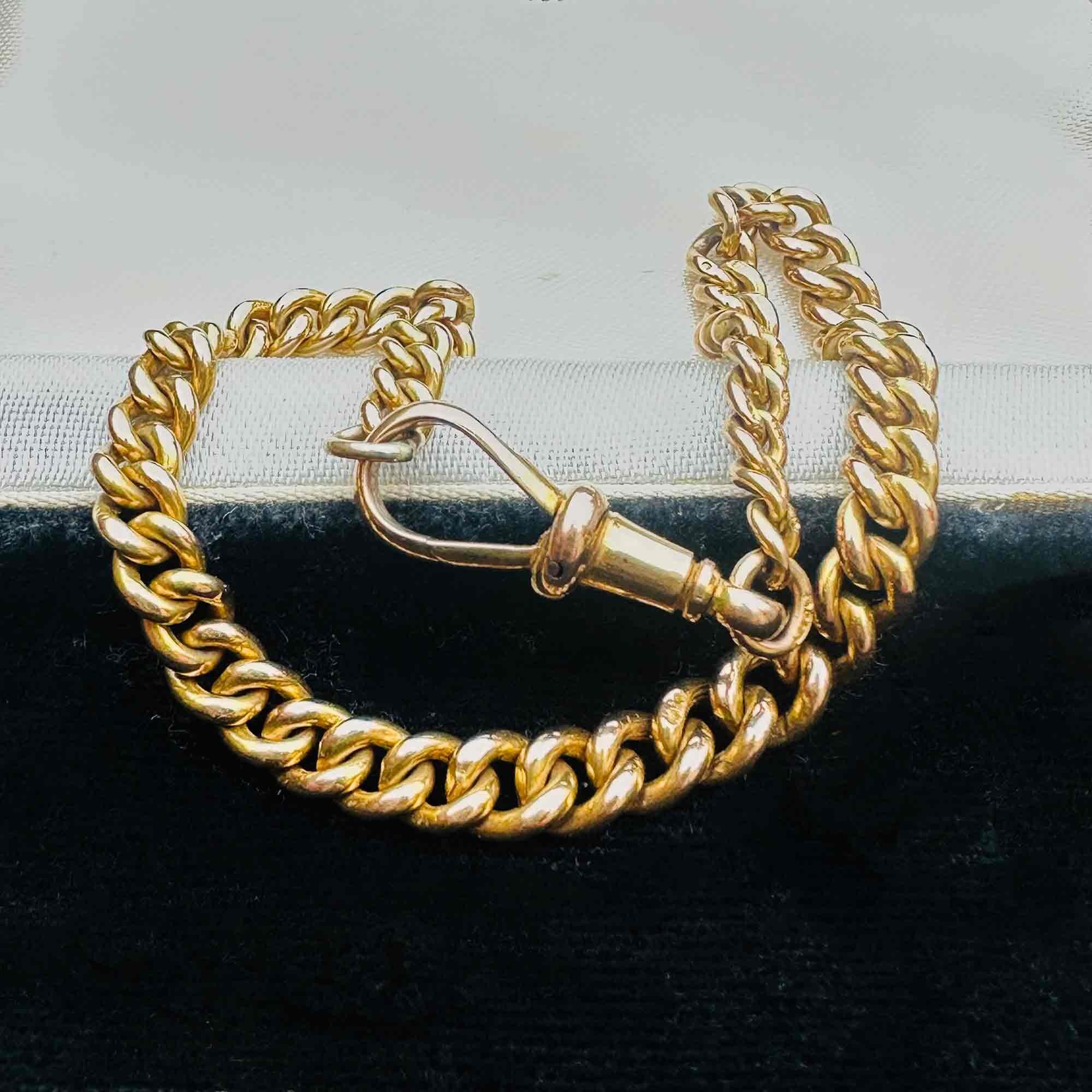 Gold Albert Curb Link  Bracelet & Dog Clip Clasp displayed laying on antique box