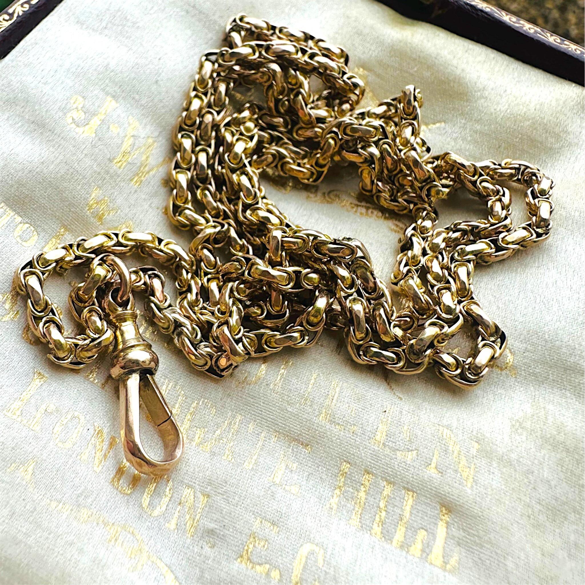 Victorian Gold Fancy Link Long Chain Necklace & Dog Clip  laying on antique box