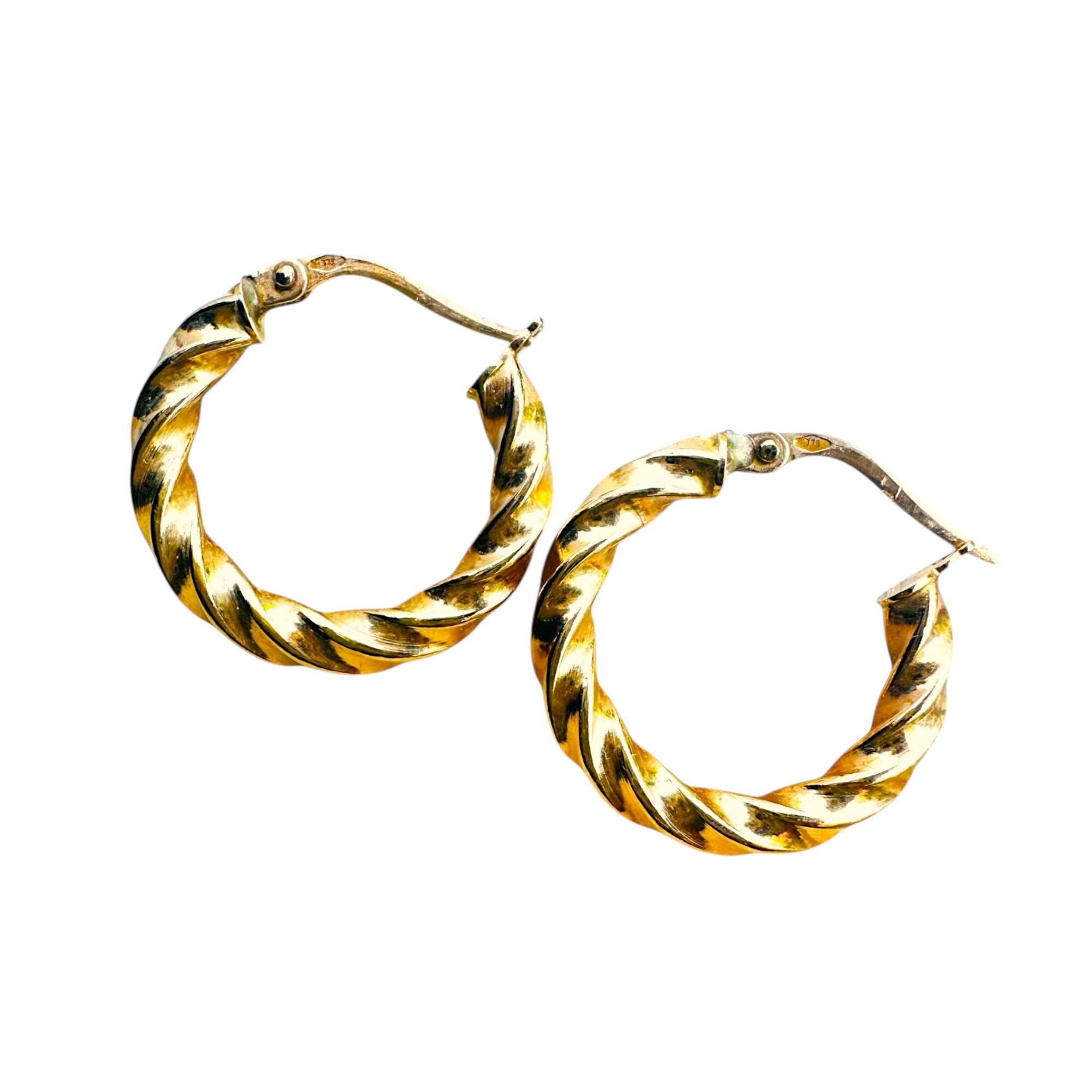 Italian 9k yellow gold twist rope hoop earrings on white background.