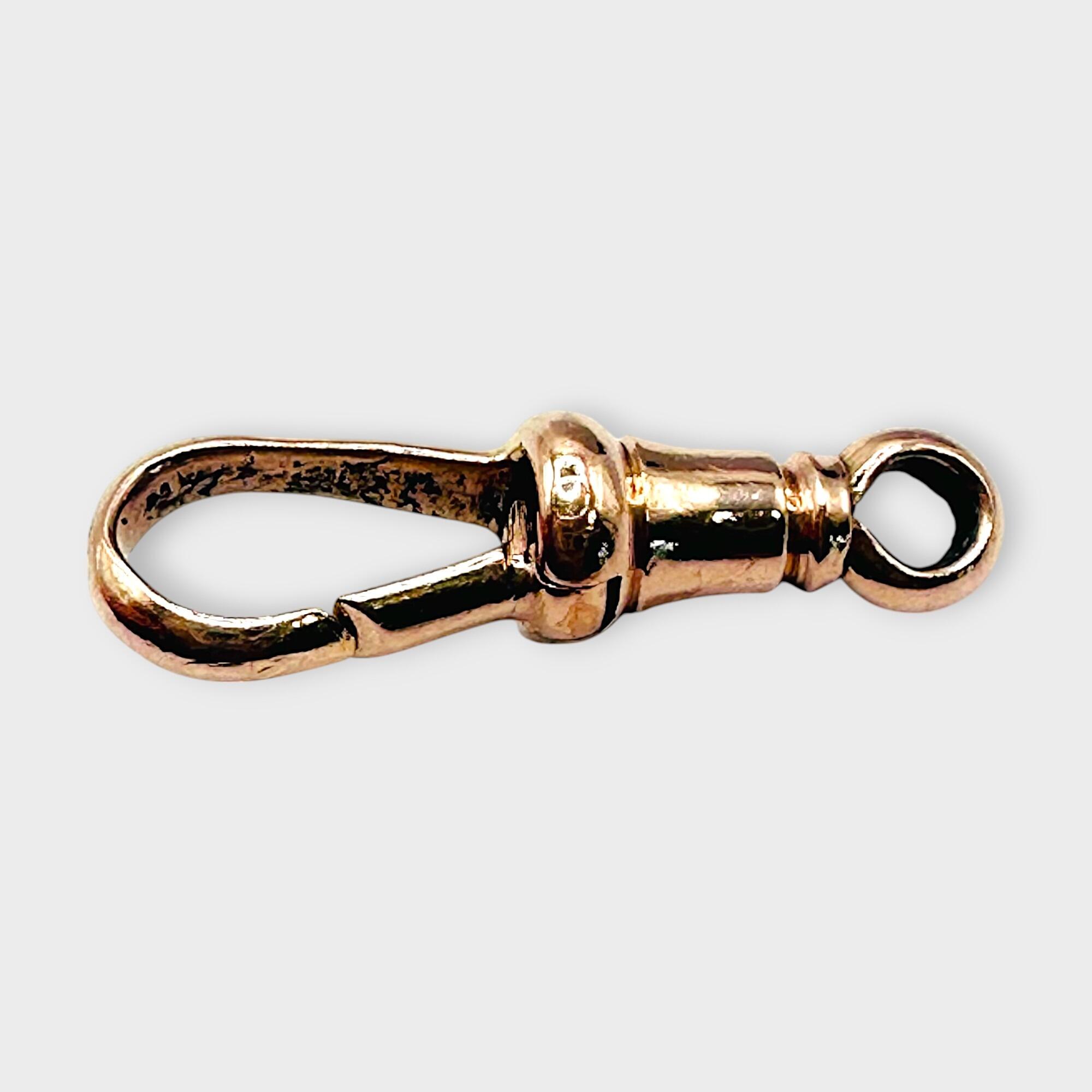 Edwardian 9ct Rose Gold dog clip clasp, on a grey background