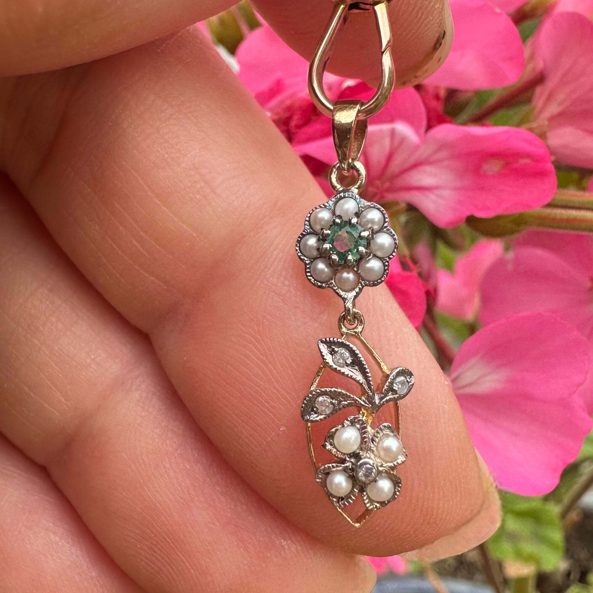 close up, Edwardian Style Emerald, Pearl & Diamond Pendant in Silver & 9k Gold held in hand.