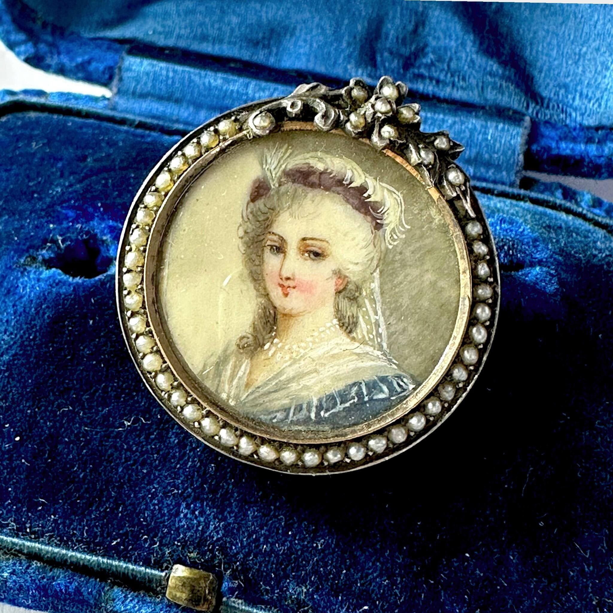 Georgian Marie Antoinette & Silver Seed Pearl Portrait Brooch displayed on blue antique box
