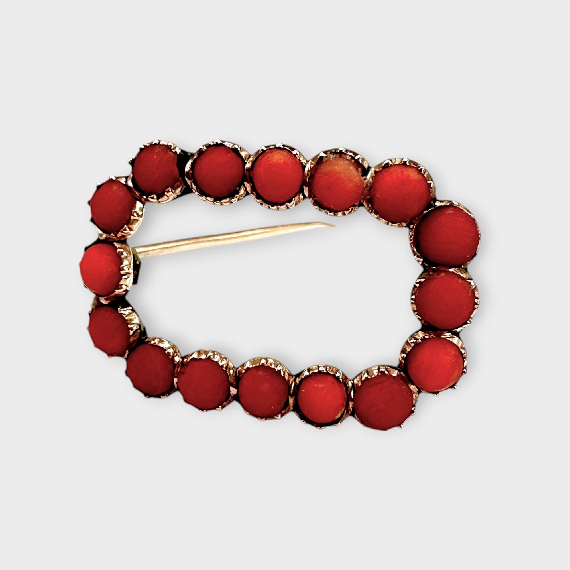 Georgian 'Salmon Red' Coral Fichu Brooch with a white background