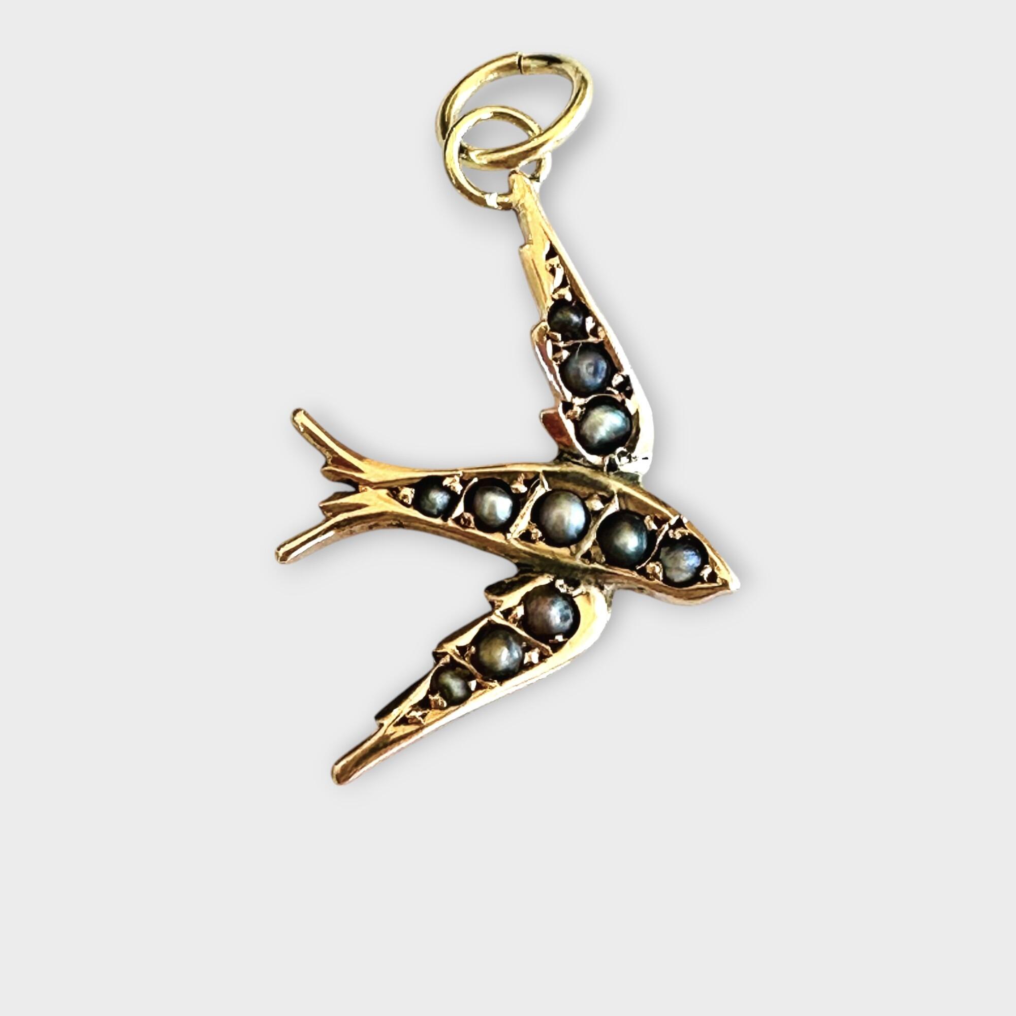 Edwardian 9ct gold pearl swallow or swift bird on grey background.