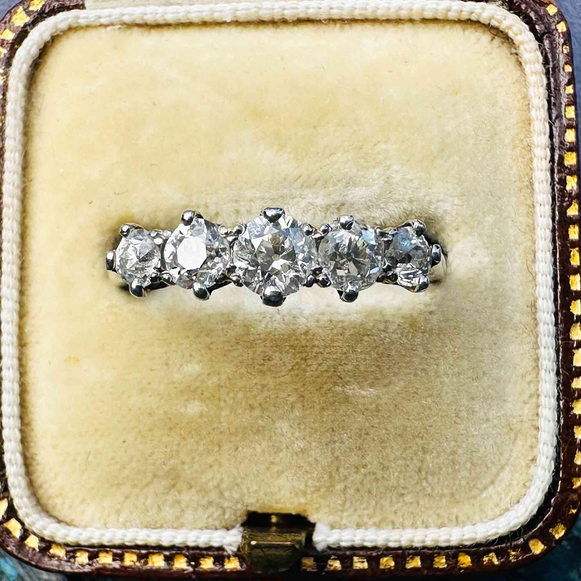Antique Edwardian diamond ring in romantic vintage setting, featuring glowing old European cut diamonds in white gold