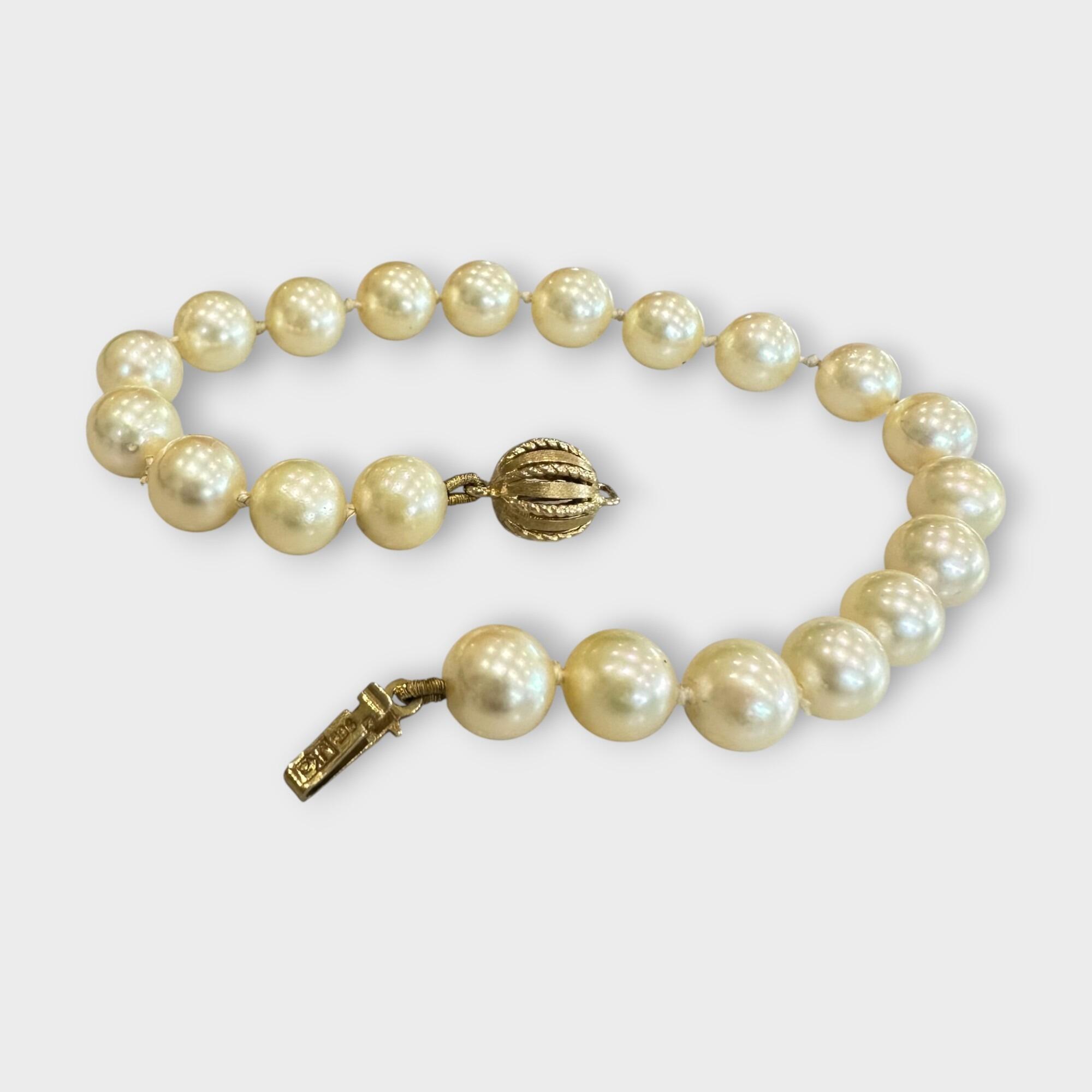 Cultured Saltwater Pearl Bracelet with 9ct Gold Ball Clasp, grey background.