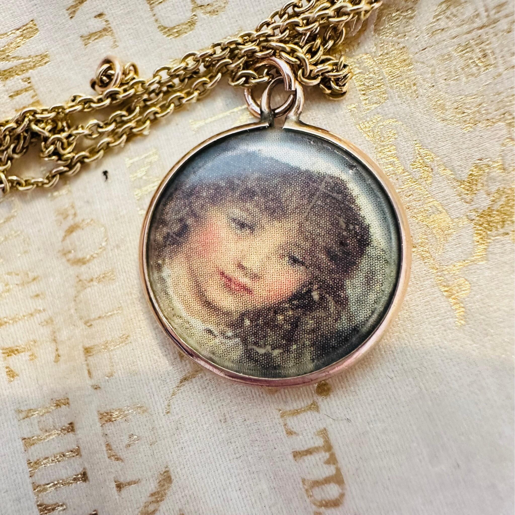 Art Nouveau Rose Gold Locket with Portrait with chain laying on a antique box