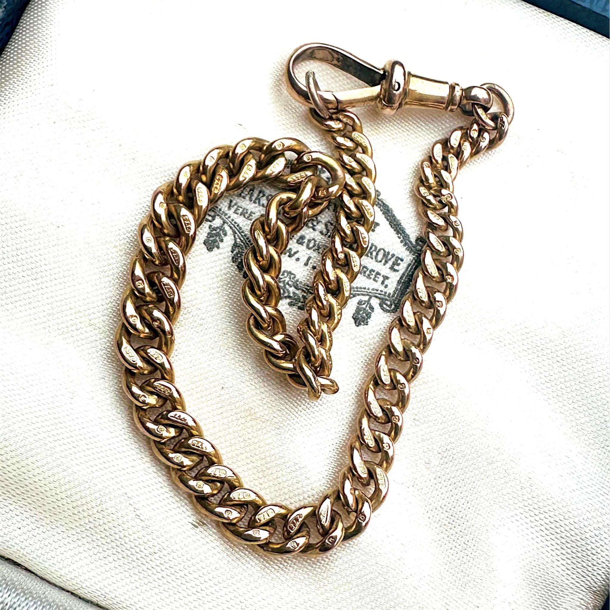 Gold Albert Curb Link  Bracelet & Dog Clip Clasp displayed laying on antique box