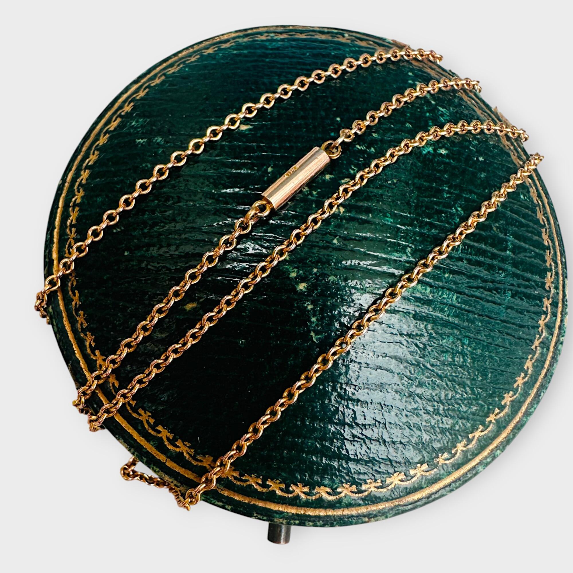 Antique 9k yellow gold rolo link chain on barrel clasp on green leather antique box.