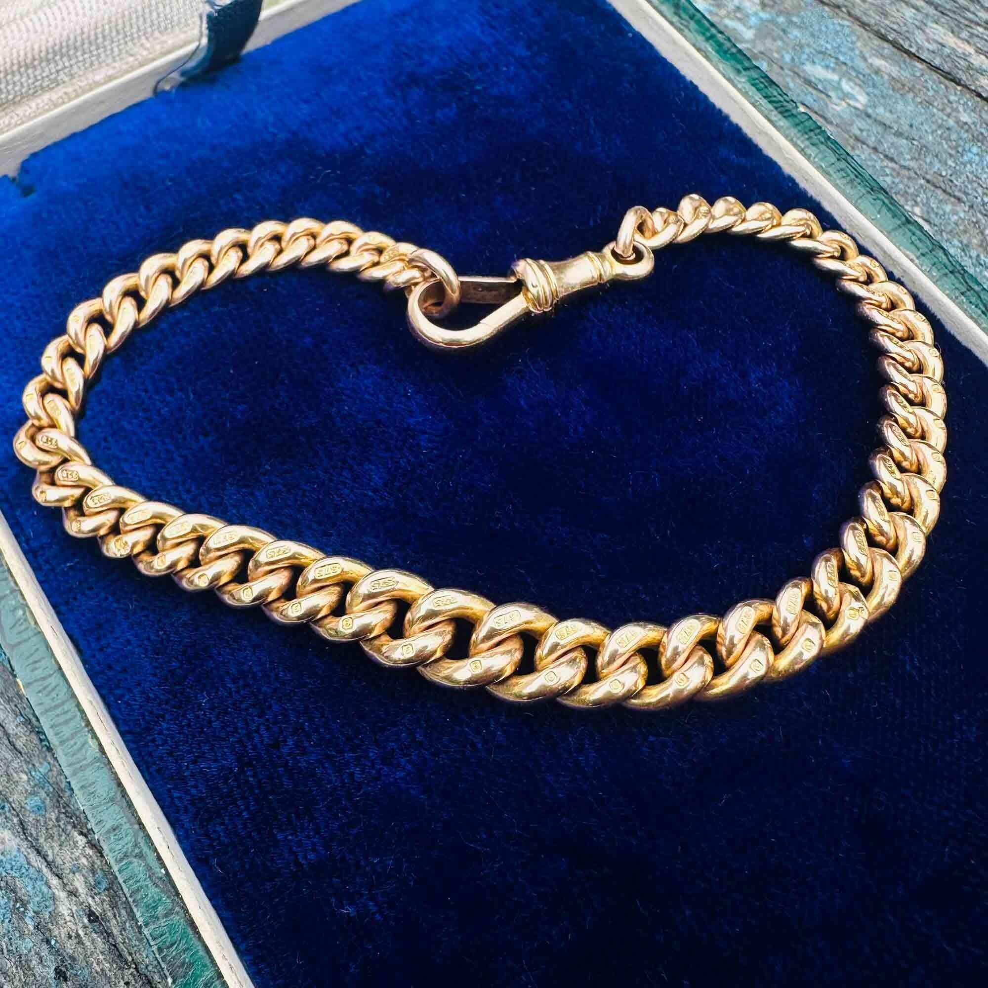 Edwardian 9k gold curb link bracelet with traditional dog clip clasp on blue velvet box.