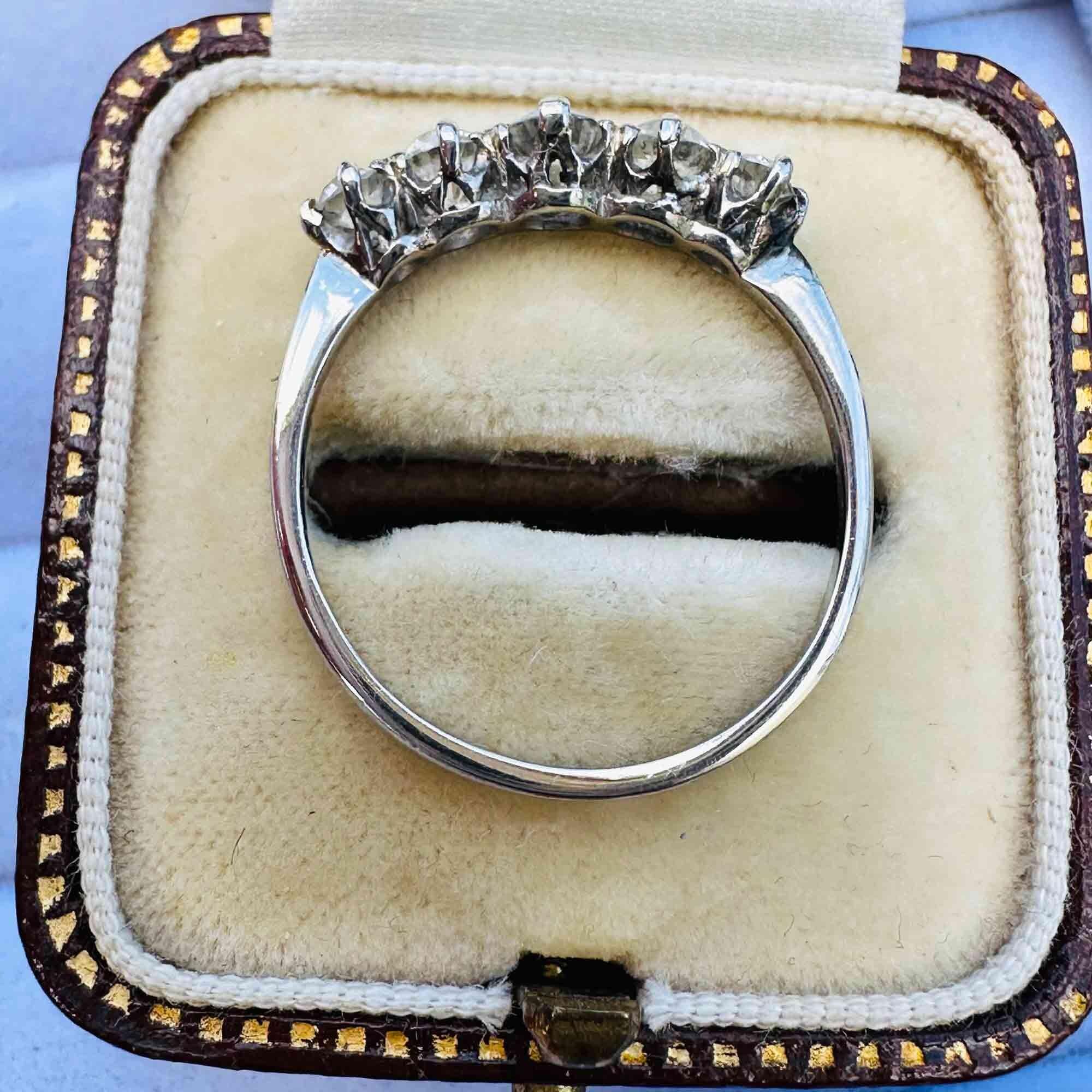 Antique Edwardian diamond ring in romantic vintage setting, featuring glowing old European cut diamonds in white gold, layed flat in antique box.