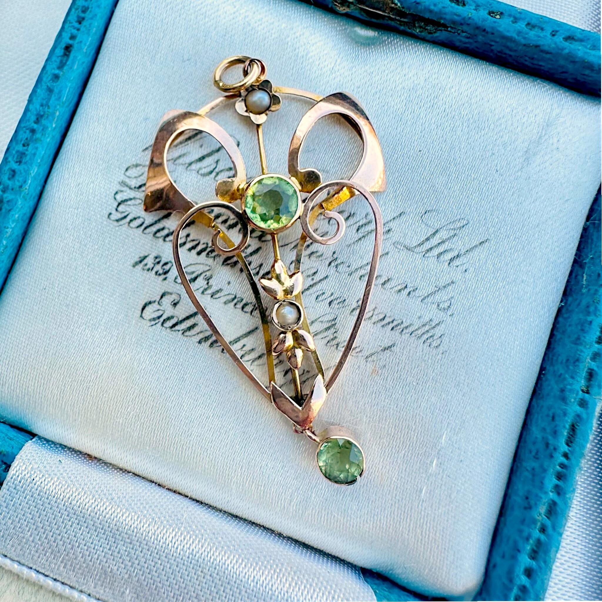 Rose Gold Peridot & Pearl Heart Pendant displayed on antique  box