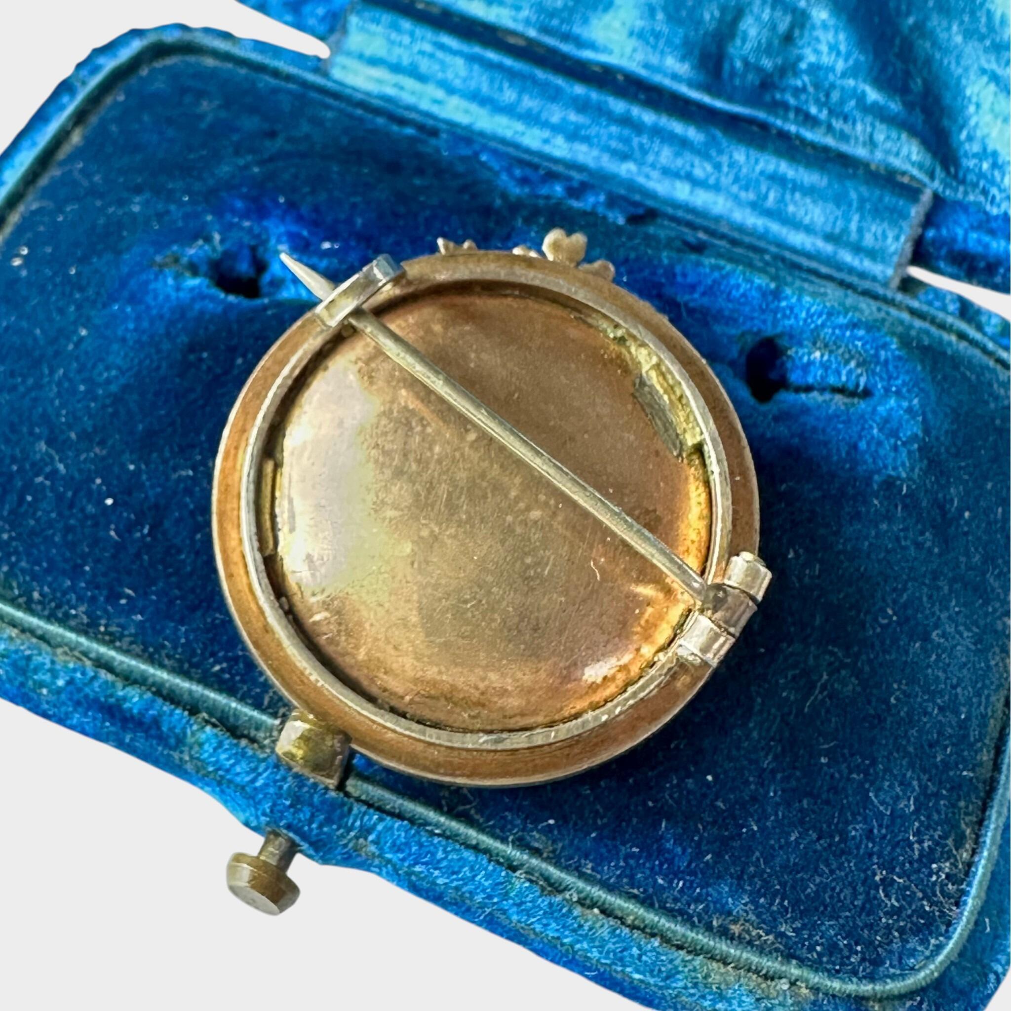 ear view of Georgian Marie Antoinette & Silver Seed Pearl Portrait Brooch displayed on blue antique box