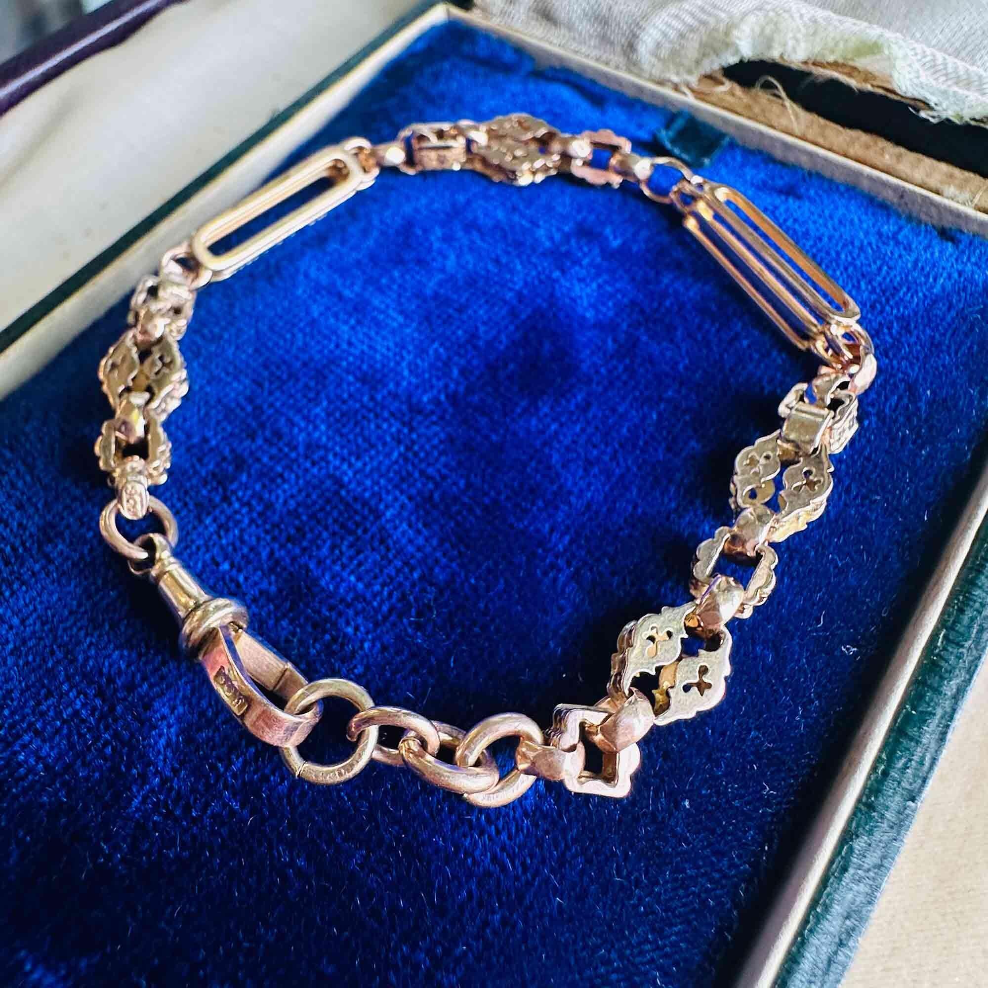 Side view of Victorian 9ct gold bracelet showing link texture and craftsmanship on blue velvet pad.