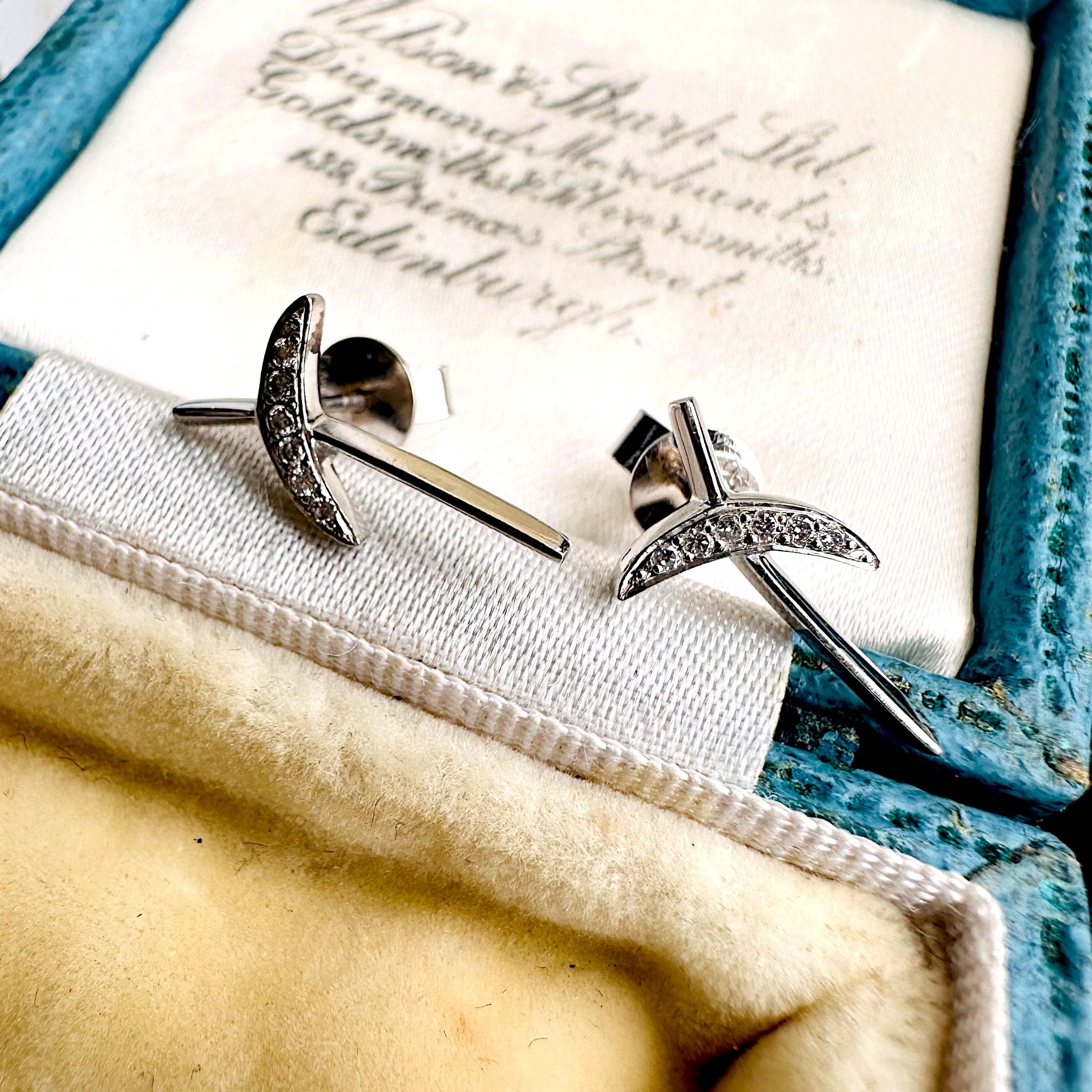 Platinum & Diamond Kiss Earrings displayed on blue antique box