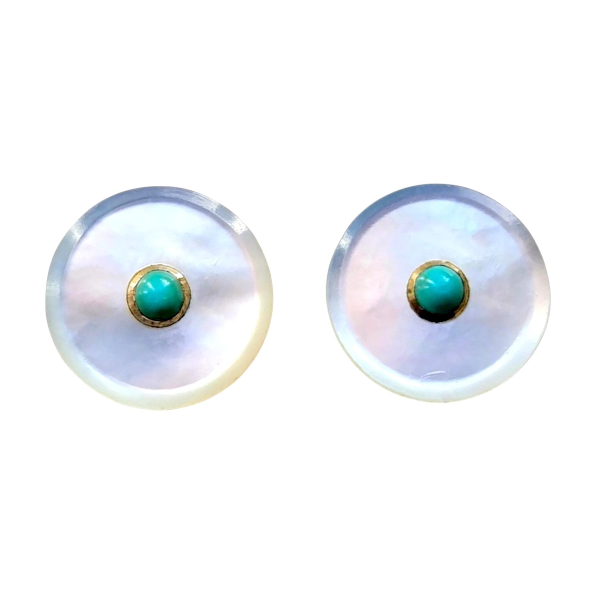 close up, pair of circular mother of pearl stud earrings with central turquoise stones with white background