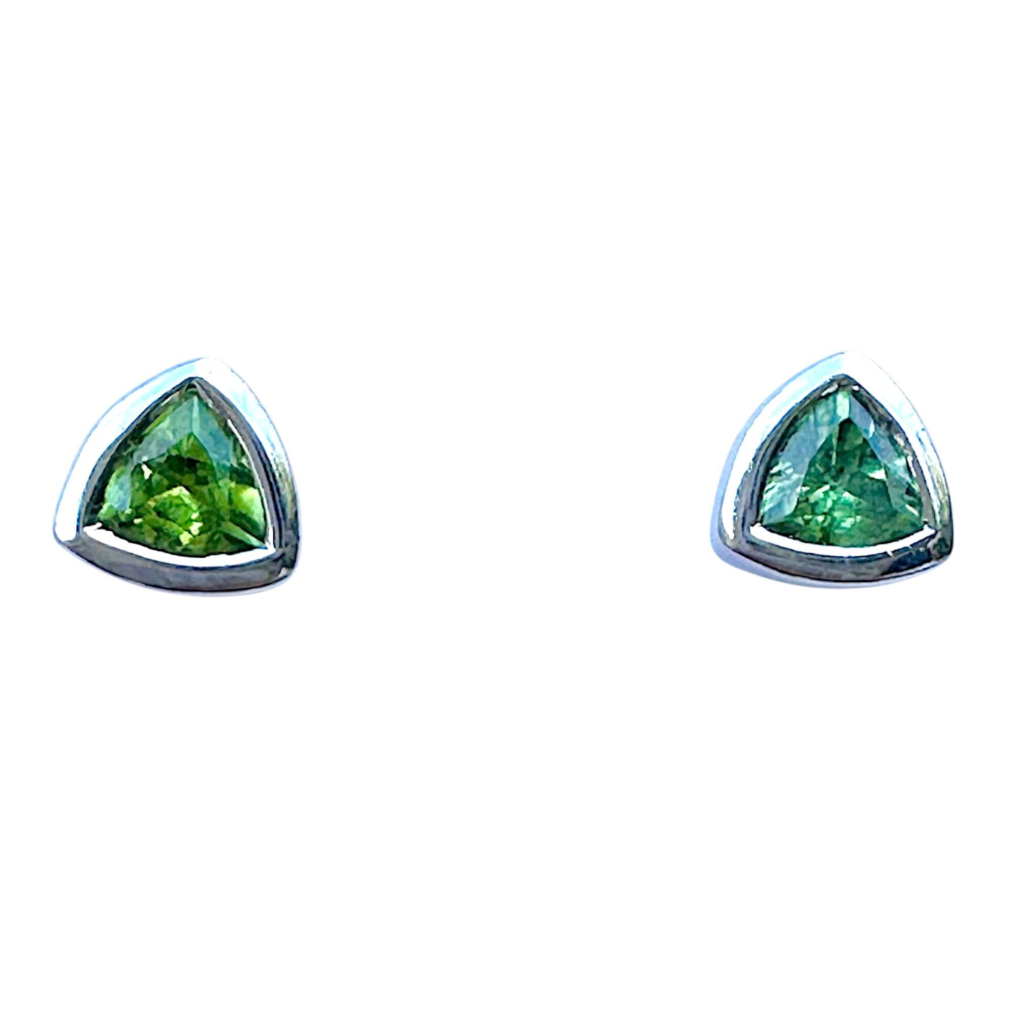 Modern pair of triangular green peridot and white gold stud earrings with butterfly fittings, with white background