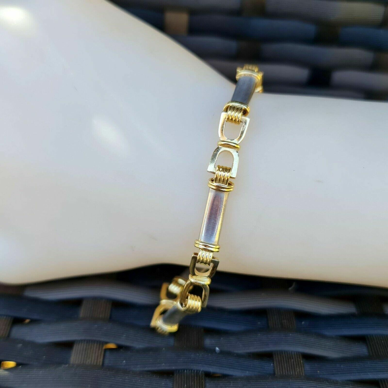 Elegant equestrian themed bracelet with yellow gold 'stirrup' style D links and white gold bar links. Designer quality, perfect for stacking!