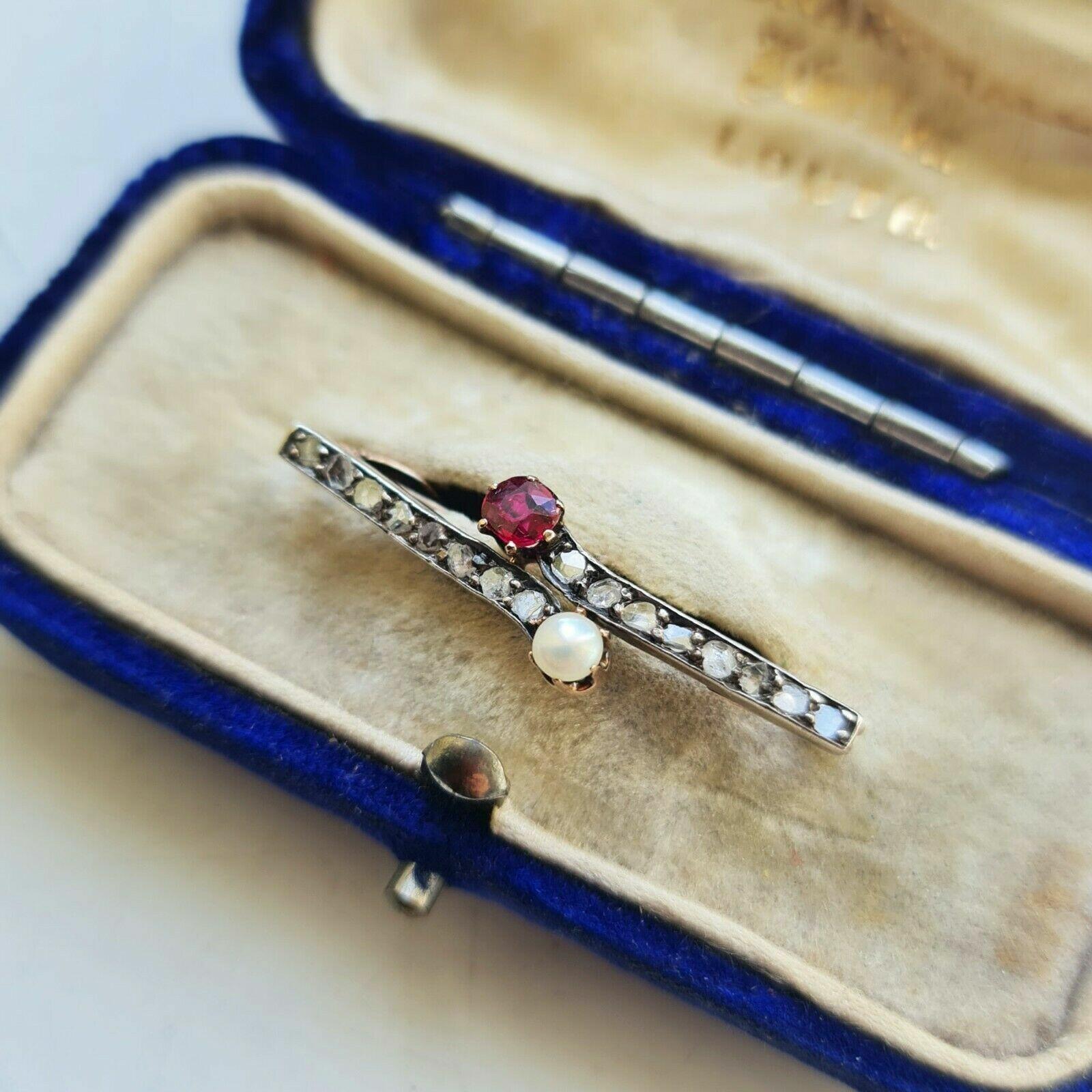 Art Nouveau brooch with rose-cut diamonds, pearls, and rubies, symbolizing purity and passion, likely a Victorian bridal gift.