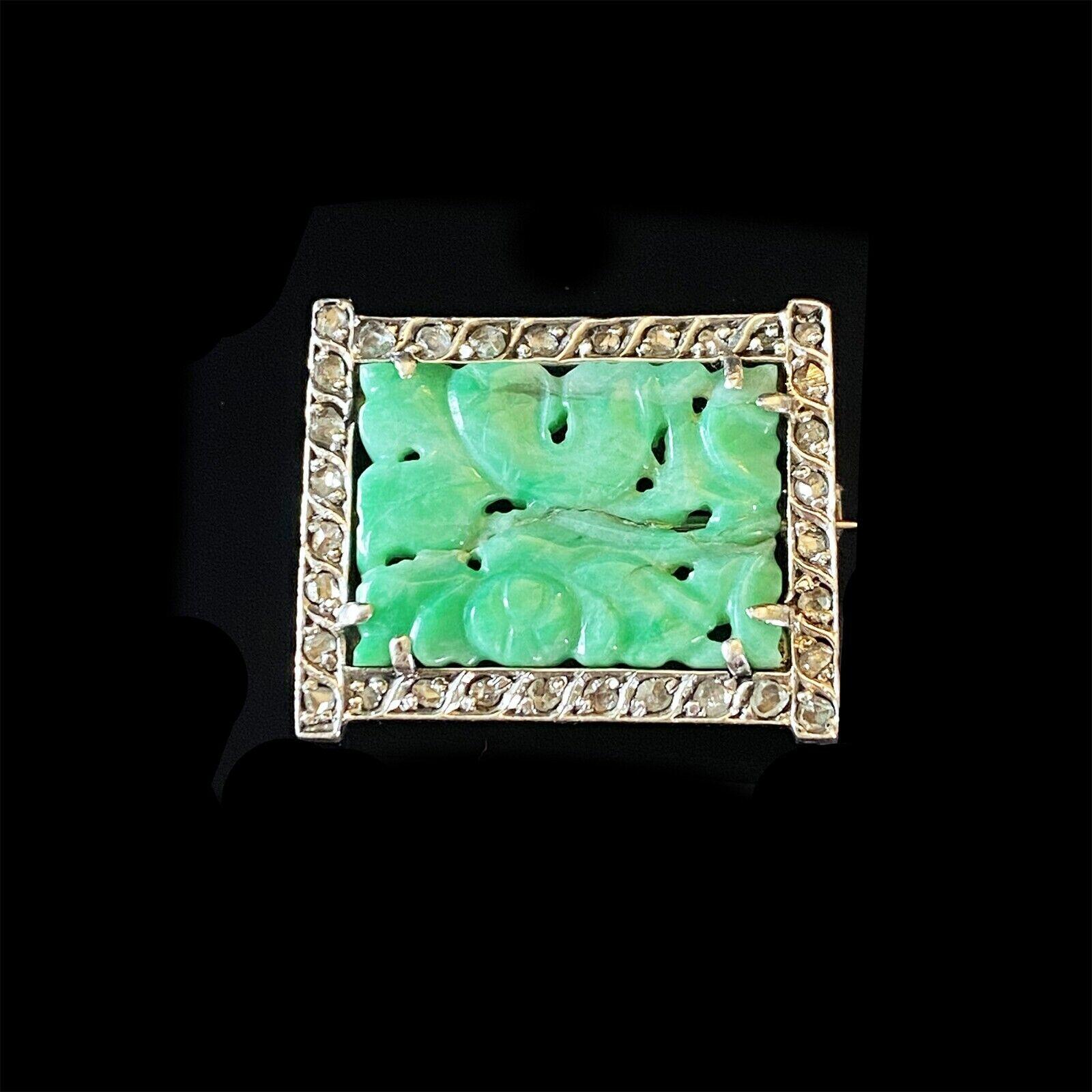 Stunning Art Deco Jadeite and Diamond brooch with carved gemstone, white gold border, and rose-cut diamonds. Crack in jade reflected in price.
