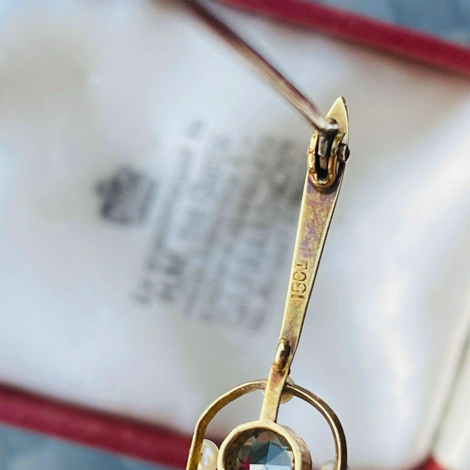 Edwardian 15ct gold bar brooch with aquamarine and seed pearls, featuring a millgrain setting and C-clasp fastening,