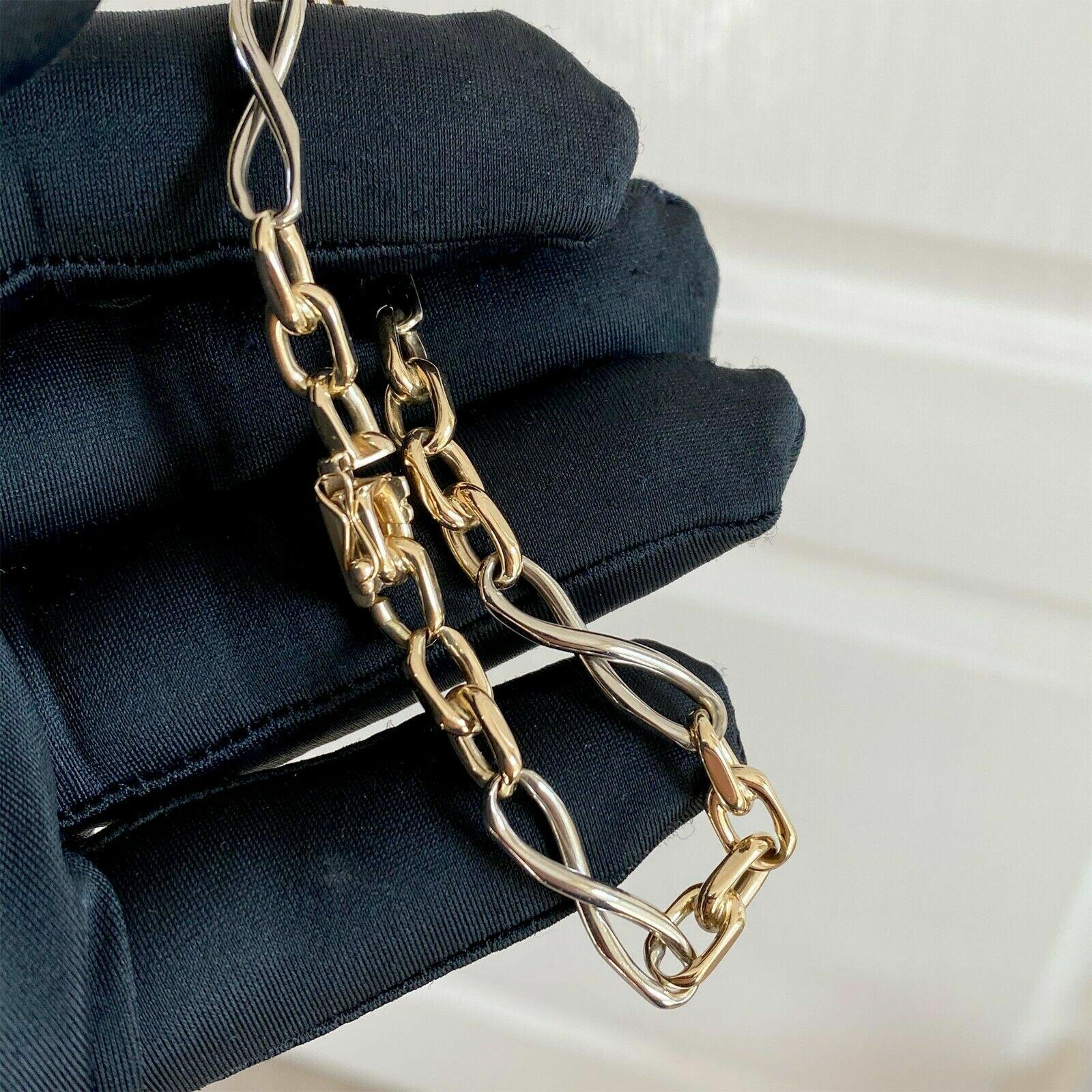 14k yellow and white gold bracelet with infinity links, 8.25 inches long, 6mm wide, 22.2 grams, with push-in clasp and safety clip.