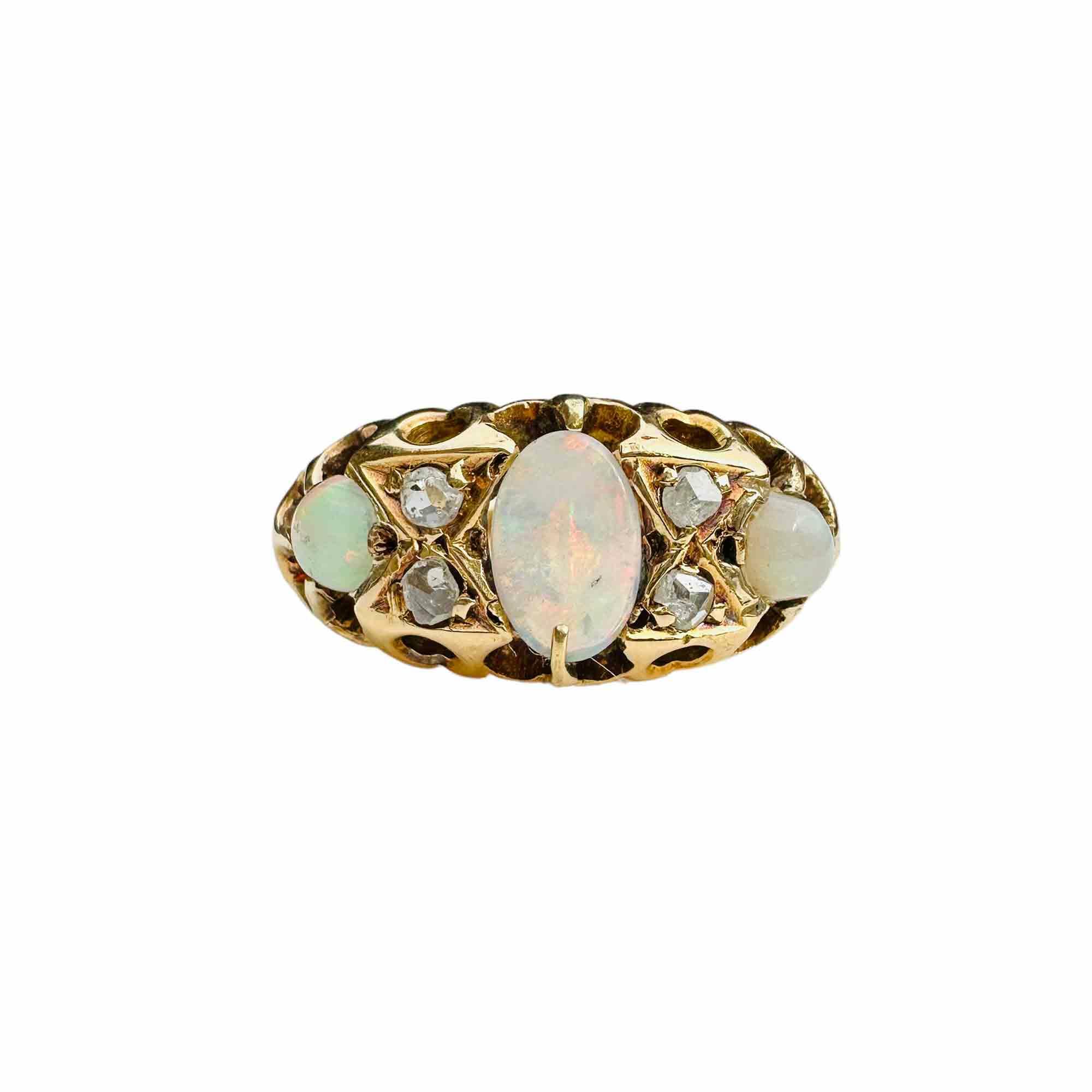 Late Victorian Art Nouveau ring with three graduating opals and four old-cut diamonds in an 18ct carved hoop setting