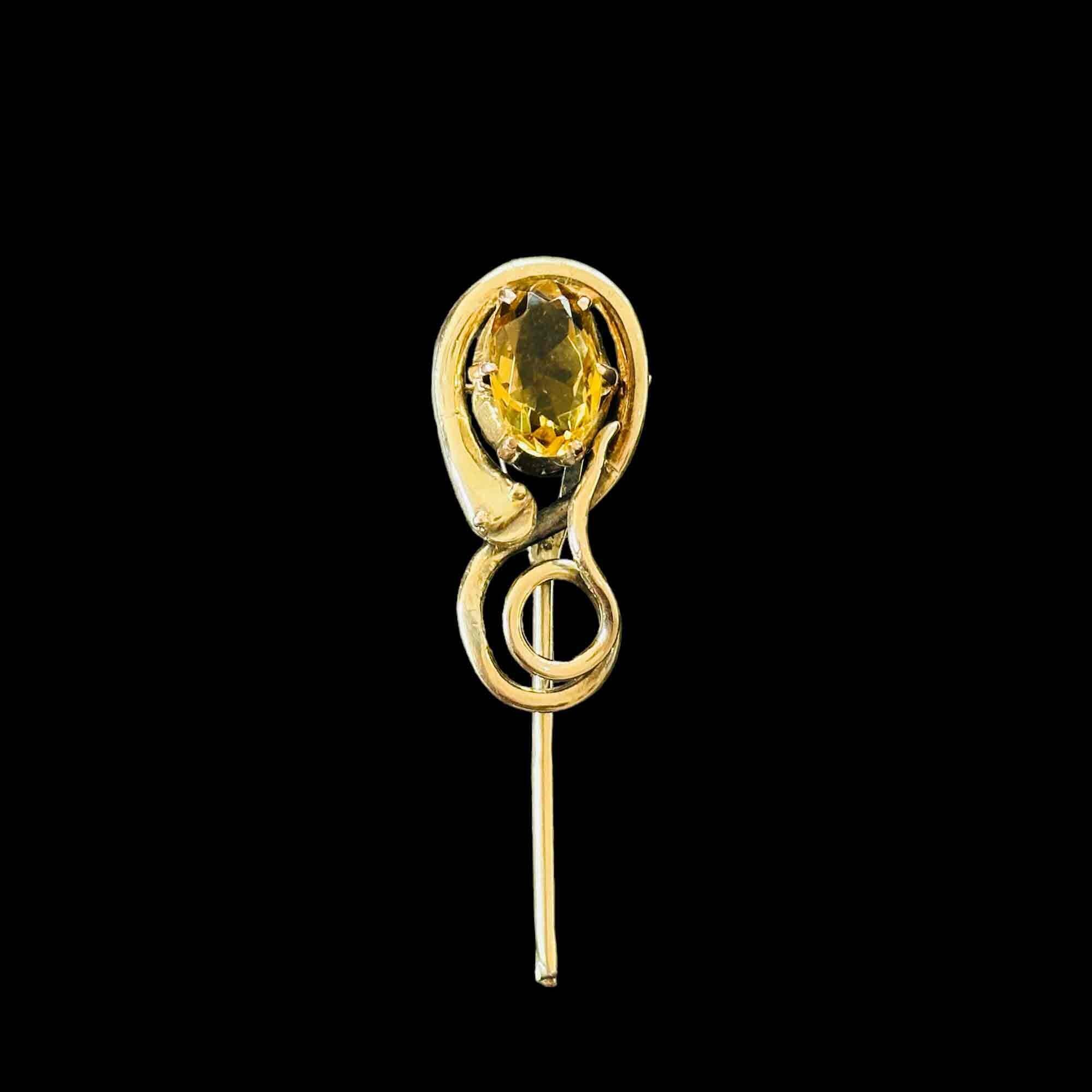Late Victorian stick pin with citrine in buttercup setting, snake motif. Large pin head, sentimental design symbolizing eternal love.
