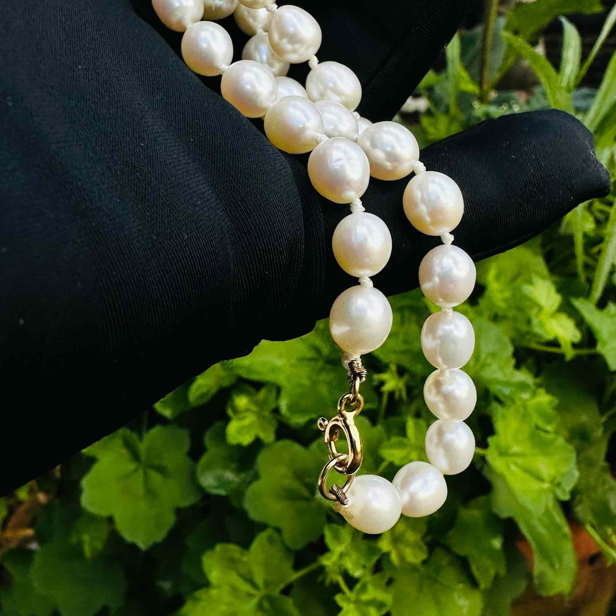 Elegant pearl necklace with creamy freshwater pearls hand-knotted on a 9ct clasp. Versatile day to night accessory with thick nacre and mirror-like sheen.