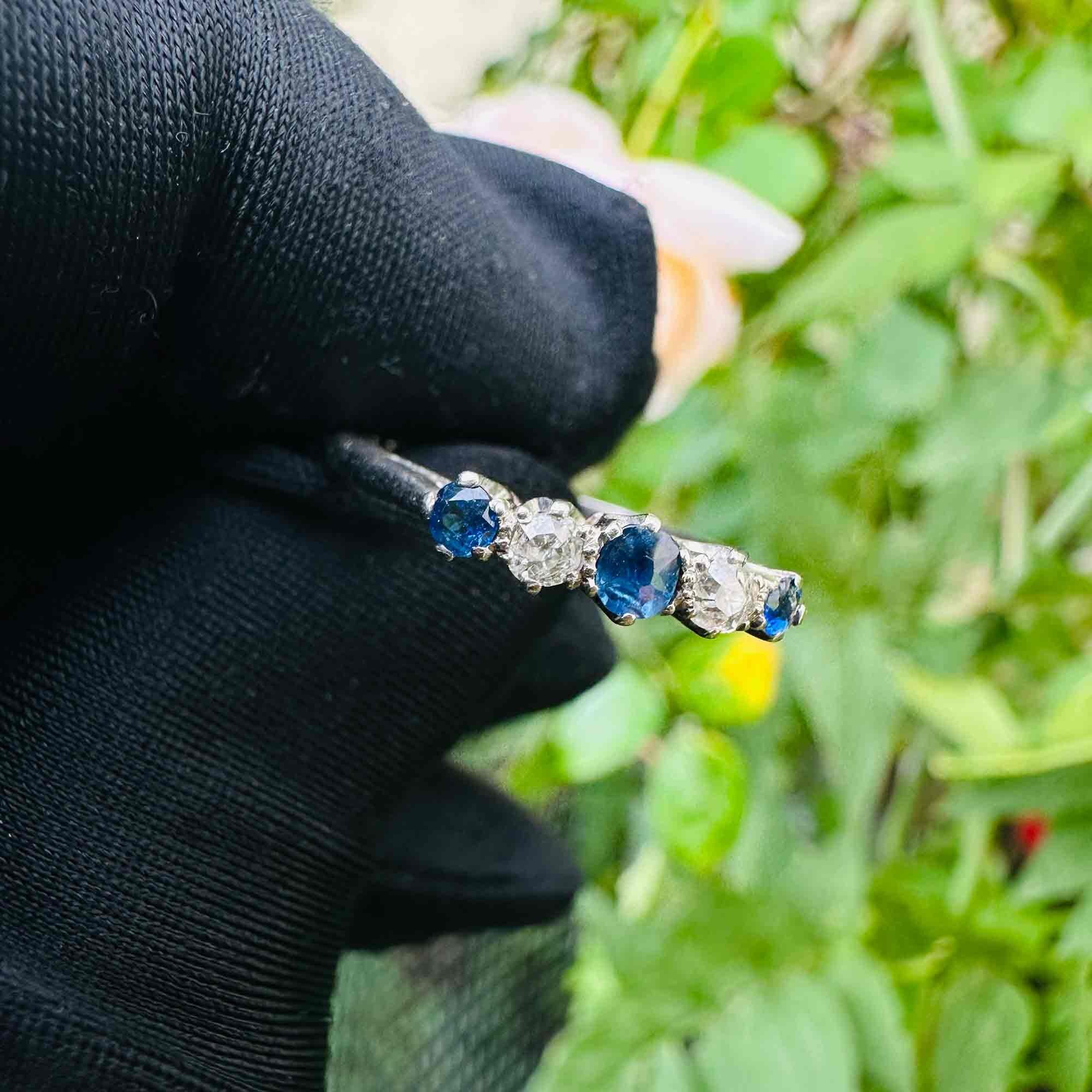 Antique engagement ring with royal blue sapphires and old-cut diamonds in platinum setting