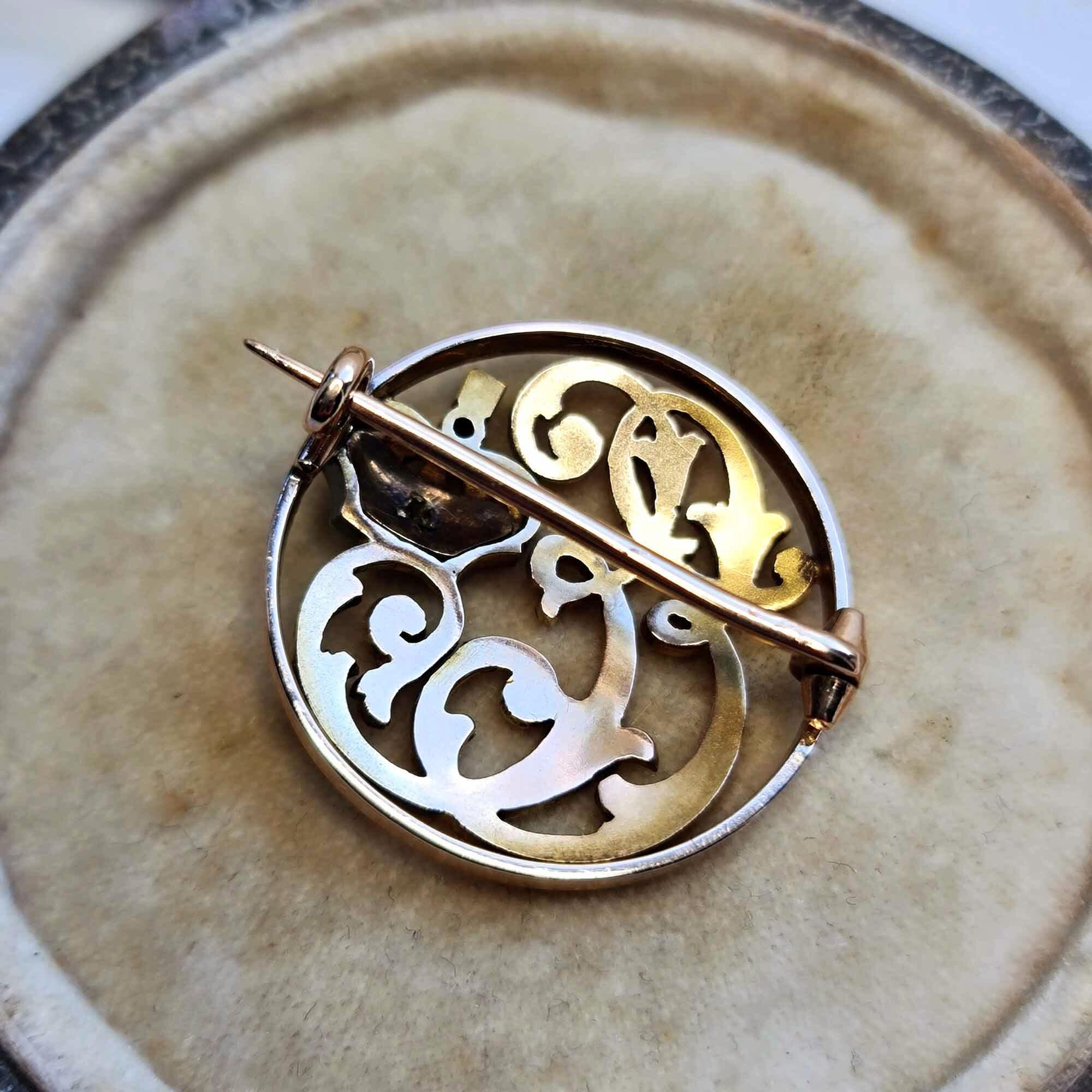 Antique monogram brooch with E initials, crown, diamonds, and red enamel