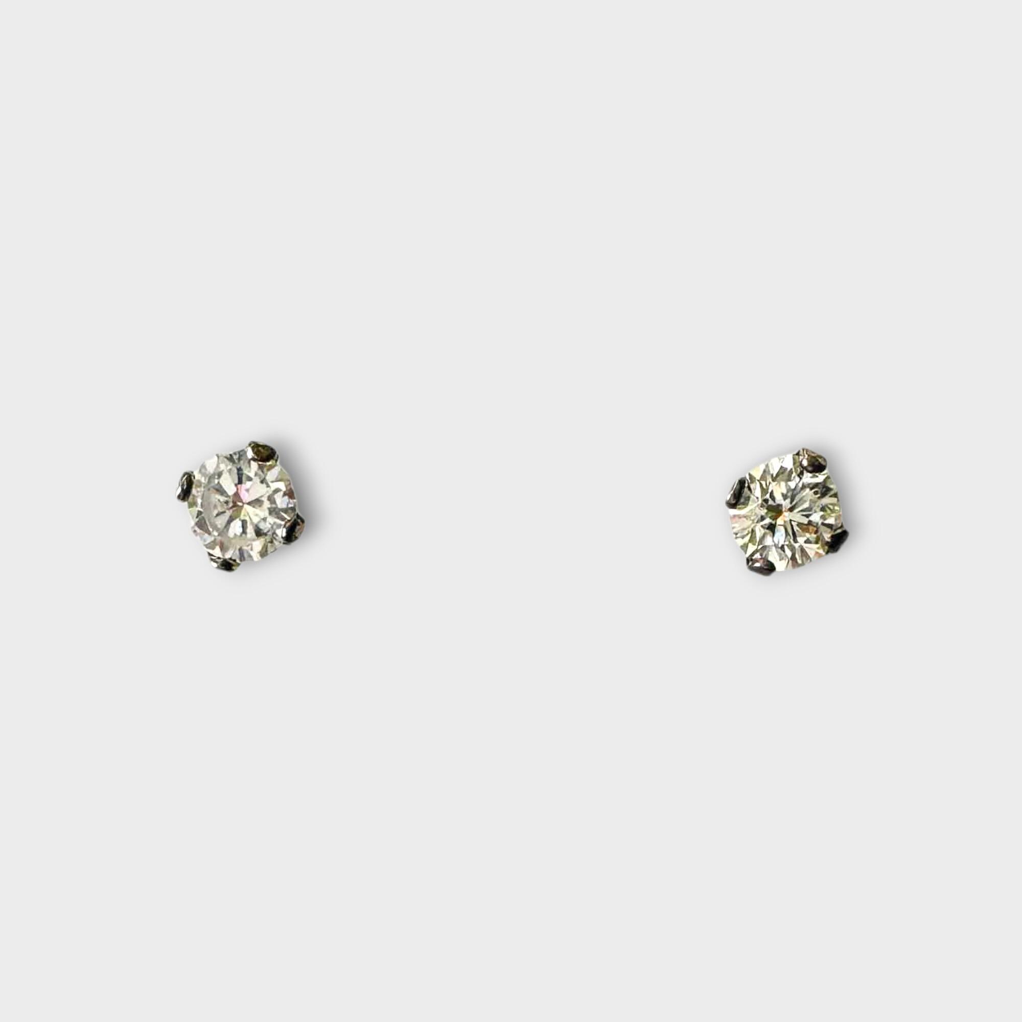 pair of solitaire diamond stud earrings in white gold