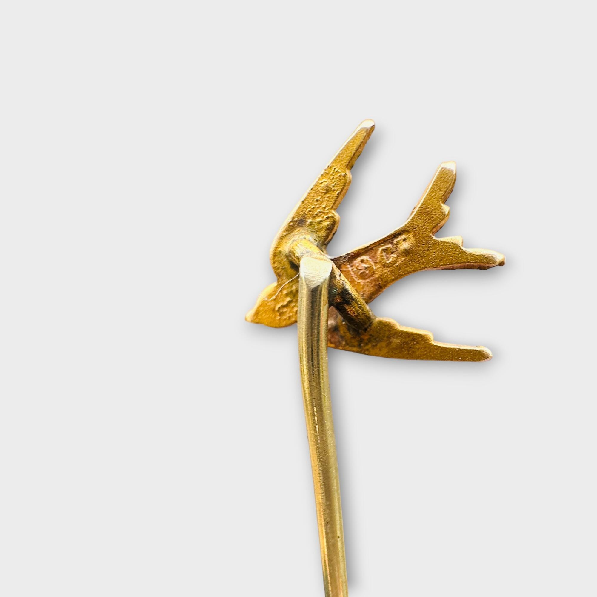 Antique Victorian stickpin with swallow bird, seed pearls, turquoise cabochons, 9ct gold, symbolizing safe journey and purity.