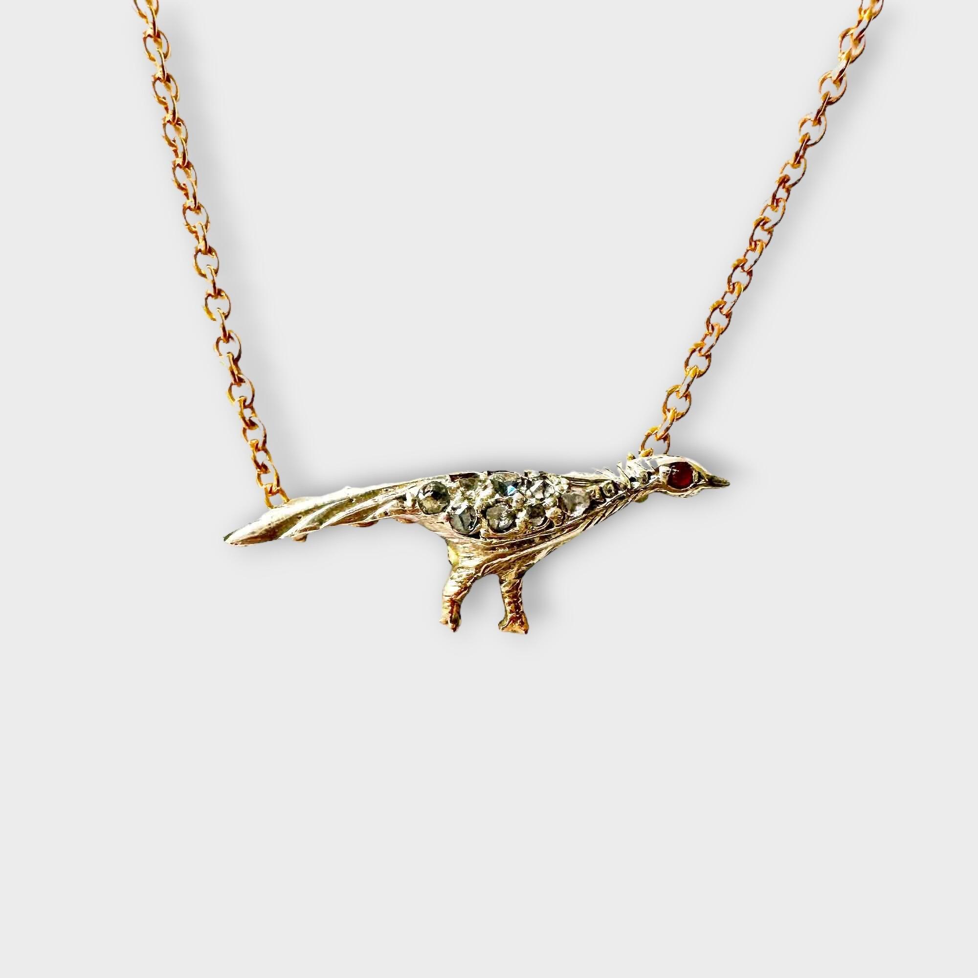 Edwardian diamond and ruby pheasant pendant with rose gold chain, intricate feather detailing, and hallmarked 9-carat gold