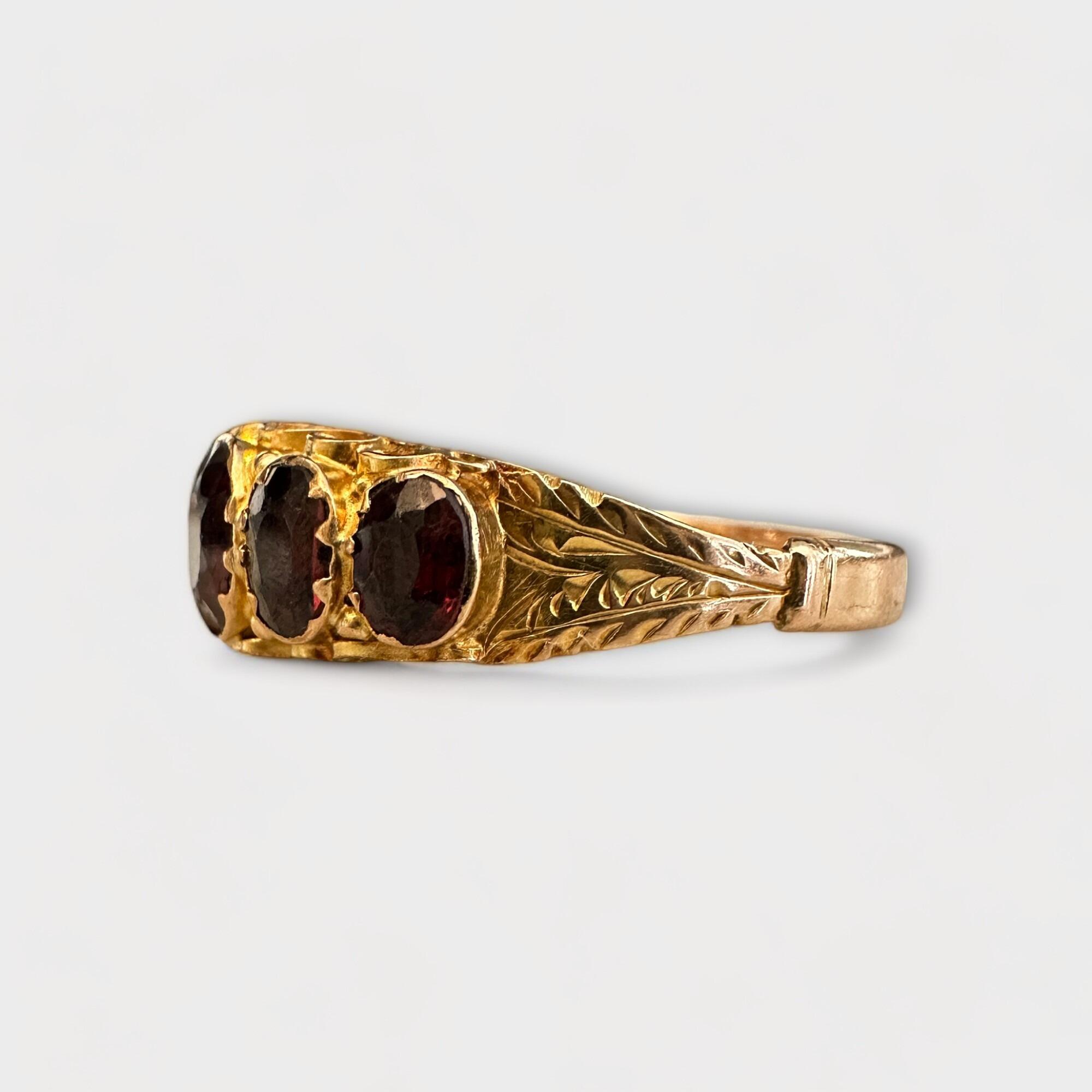 Hand-crafted Victorian ring with faceted pyrope garnets in gold setting. Engraved foliate design, UK size R, 2.1g, 9ct gold hallmark.