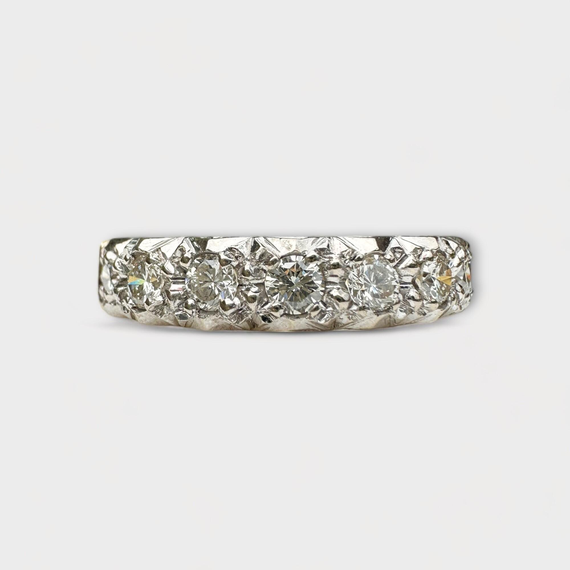 wide white gold half eternity ring with seven diamonds