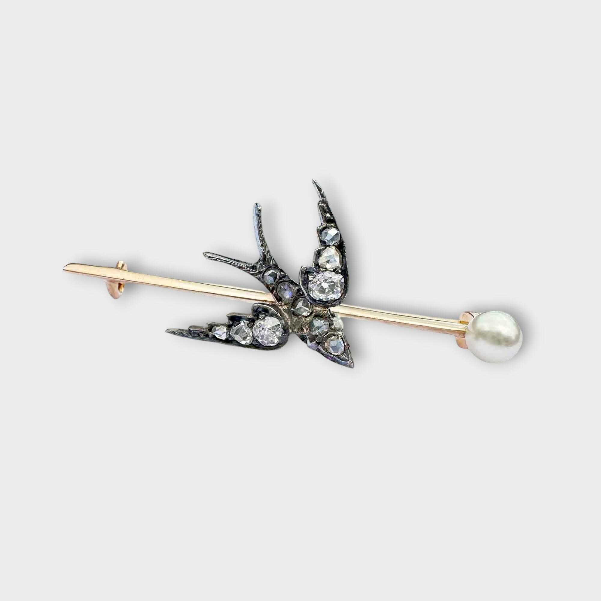 Edwardian bar brooch with diamond-studded swallow, ruby eyes, and pearl terminal, symbolizing eternal love and safe return.