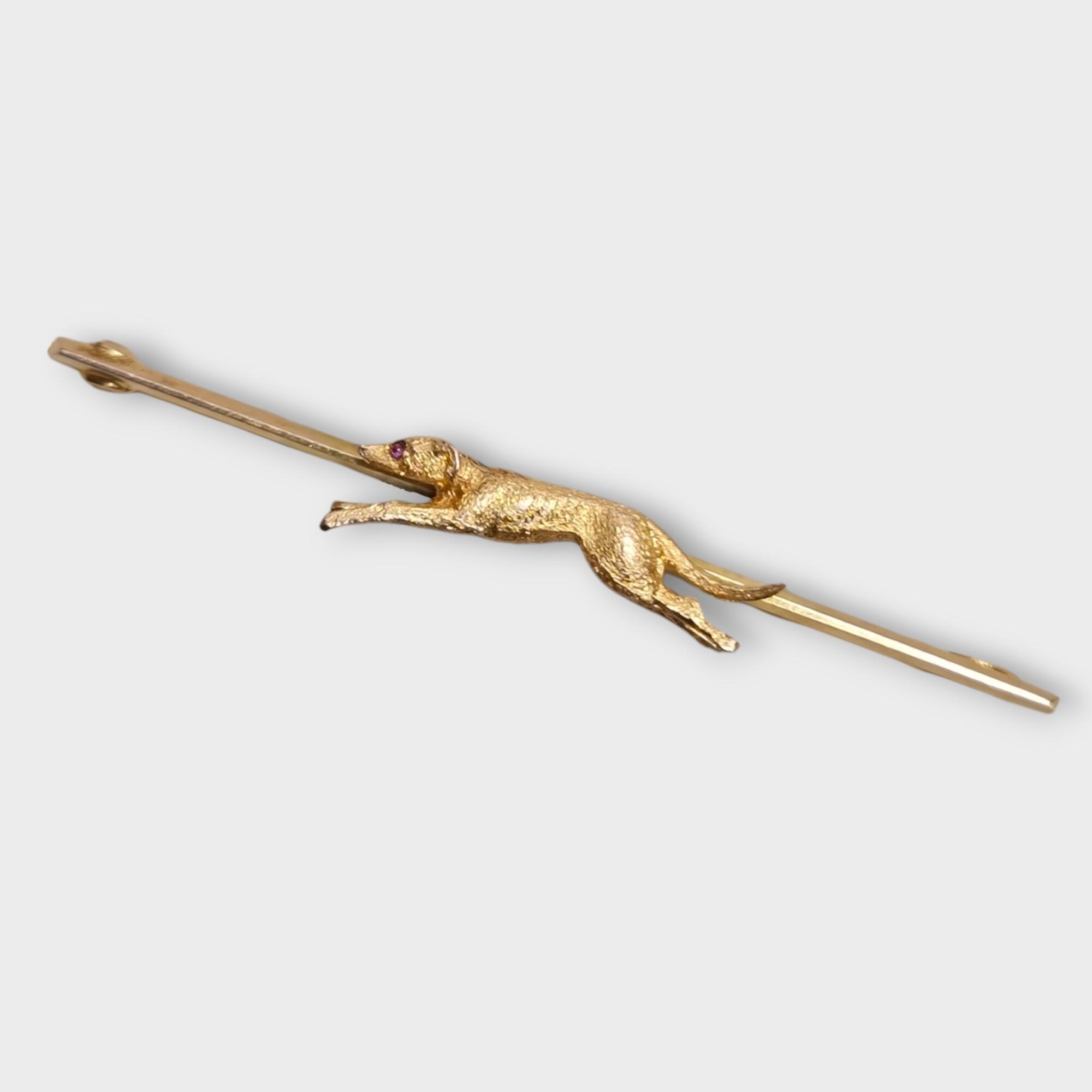 yellow gold running dog bar brooch with ruby eye accent