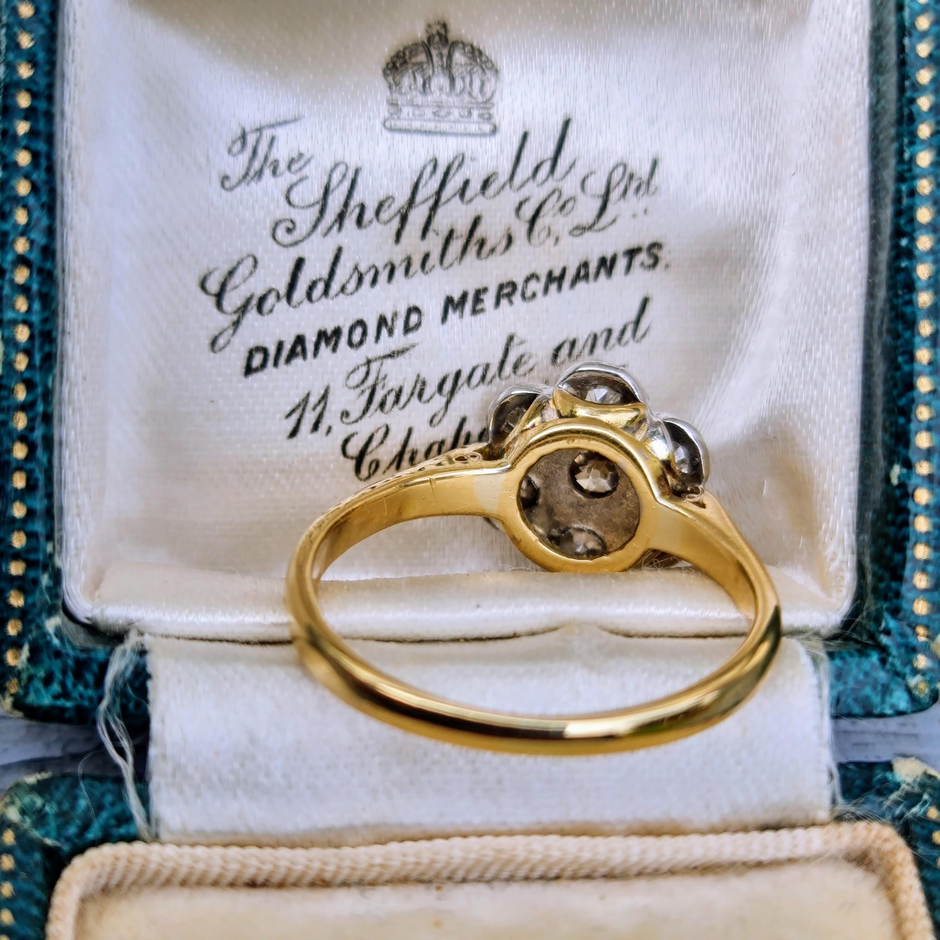 Victorian old-mine diamond daisy cluster ring in 18ct gold with chenier shoulders, full of old-world charm and character.