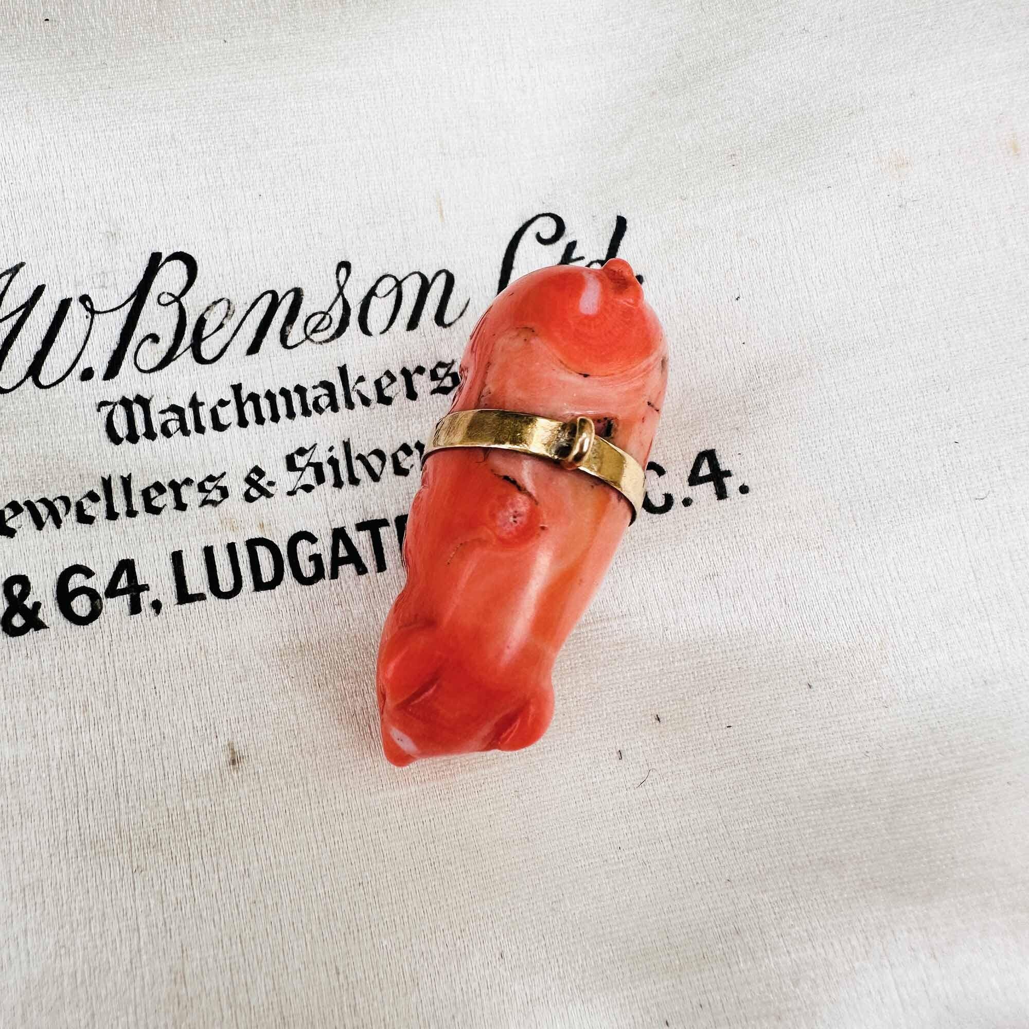 Victorian antique pig charm in genuine coral with 18ct gold waistband, finely detailed, symbolizing prosperity and luck.