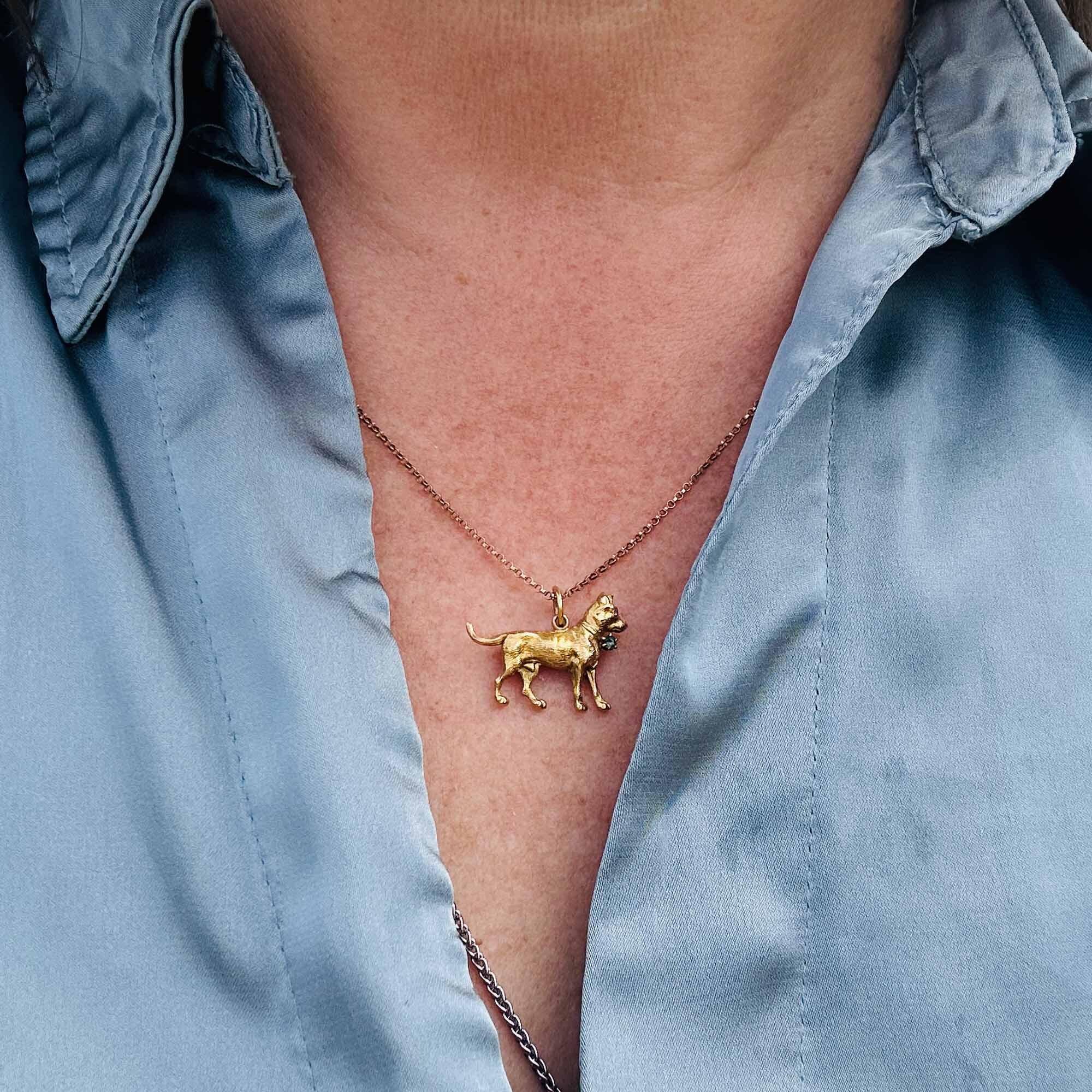 Edwardian standing dog pendant in rich yellow gold with emerald collar and ruby eye. Textured finish and fine details. Measurements: 21.5 x 16mm, Weight: 1.3 grams.