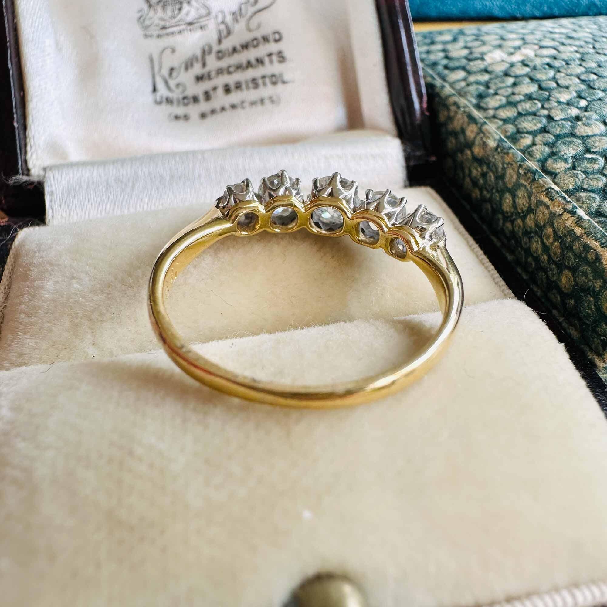 Antique engagement ring with five old-cut diamonds in platinum settings. Diamonds are eye clean, bright & fiery, estimated 1.00ct total weight.