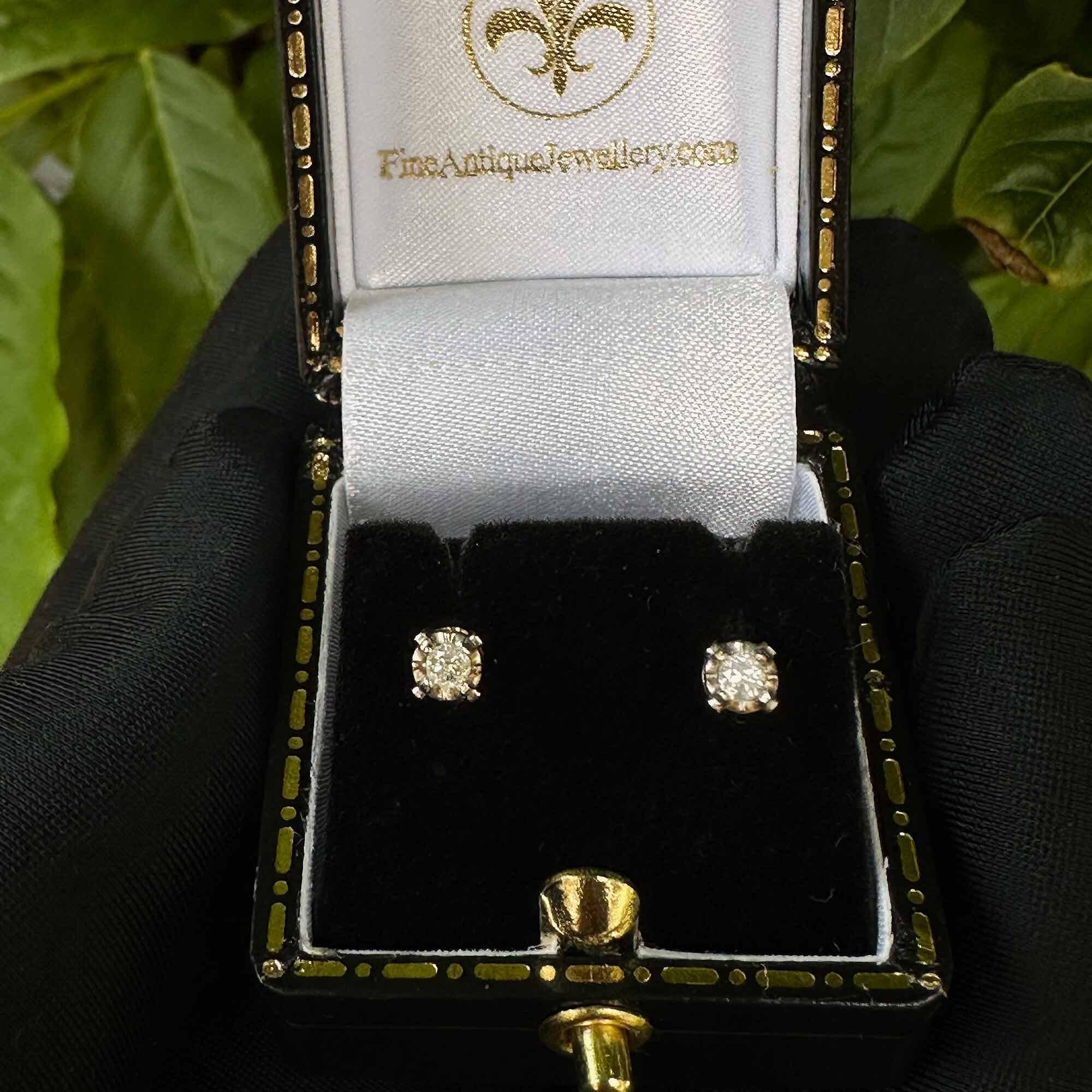 White gold diamond solitaire earrings with illusion setting, perfect for everyday wear. Birthstone for April.