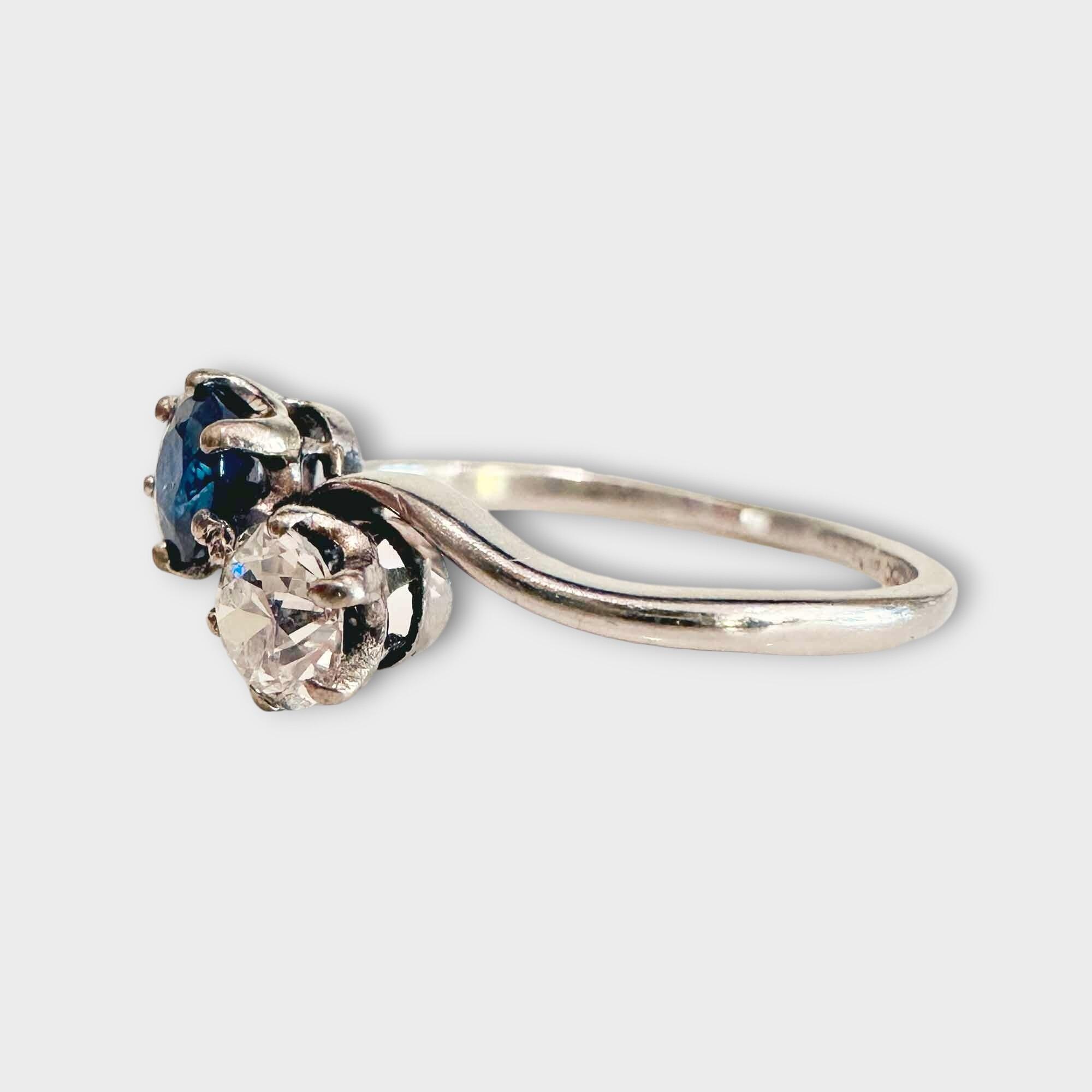 Edwardian 'Toi et Moi' engagement ring, circa 1910, featuring a sapphire and diamond set in platinum with crossover shoulders.