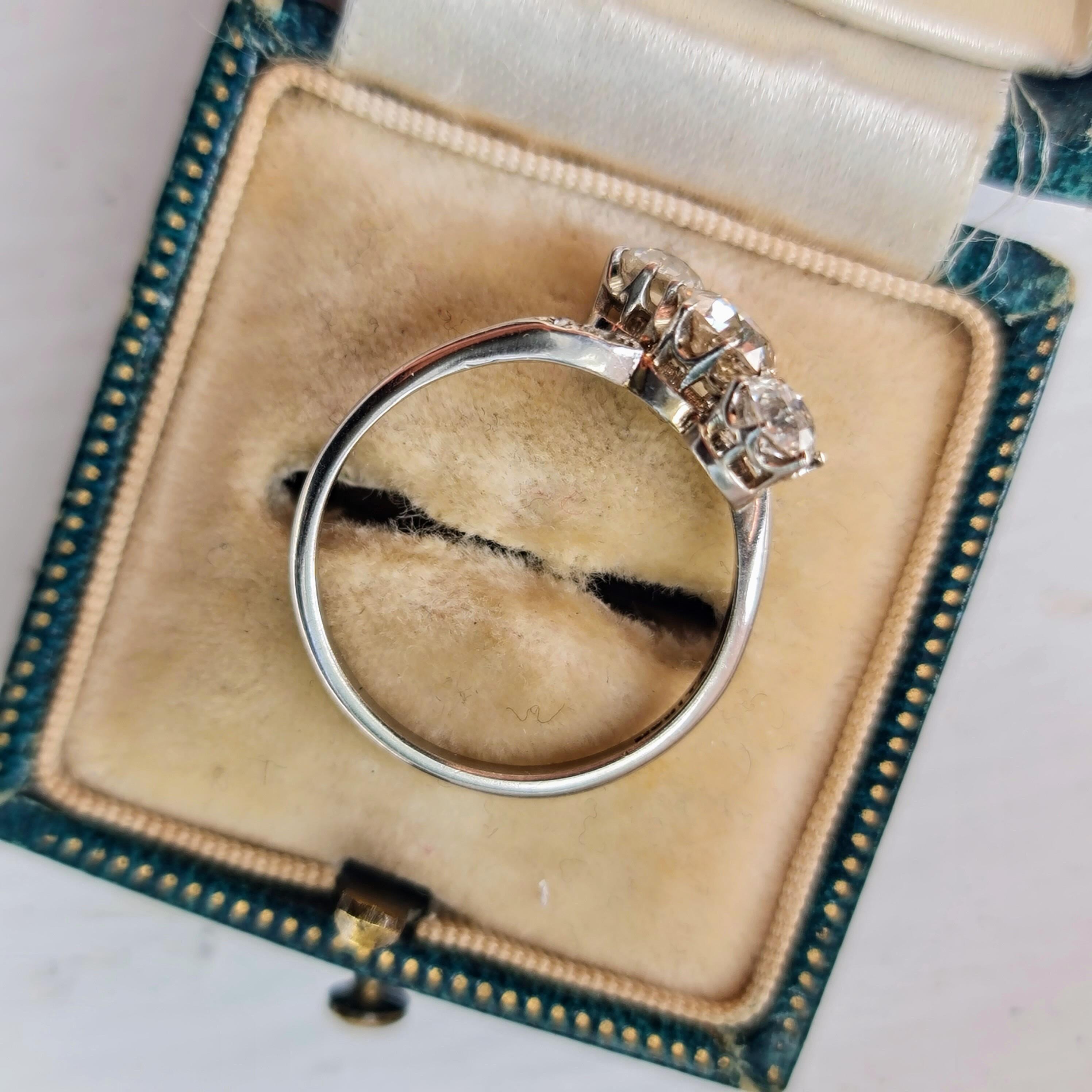 Art Deco diagonally set three stone old cut diamond engagement ring in platinum