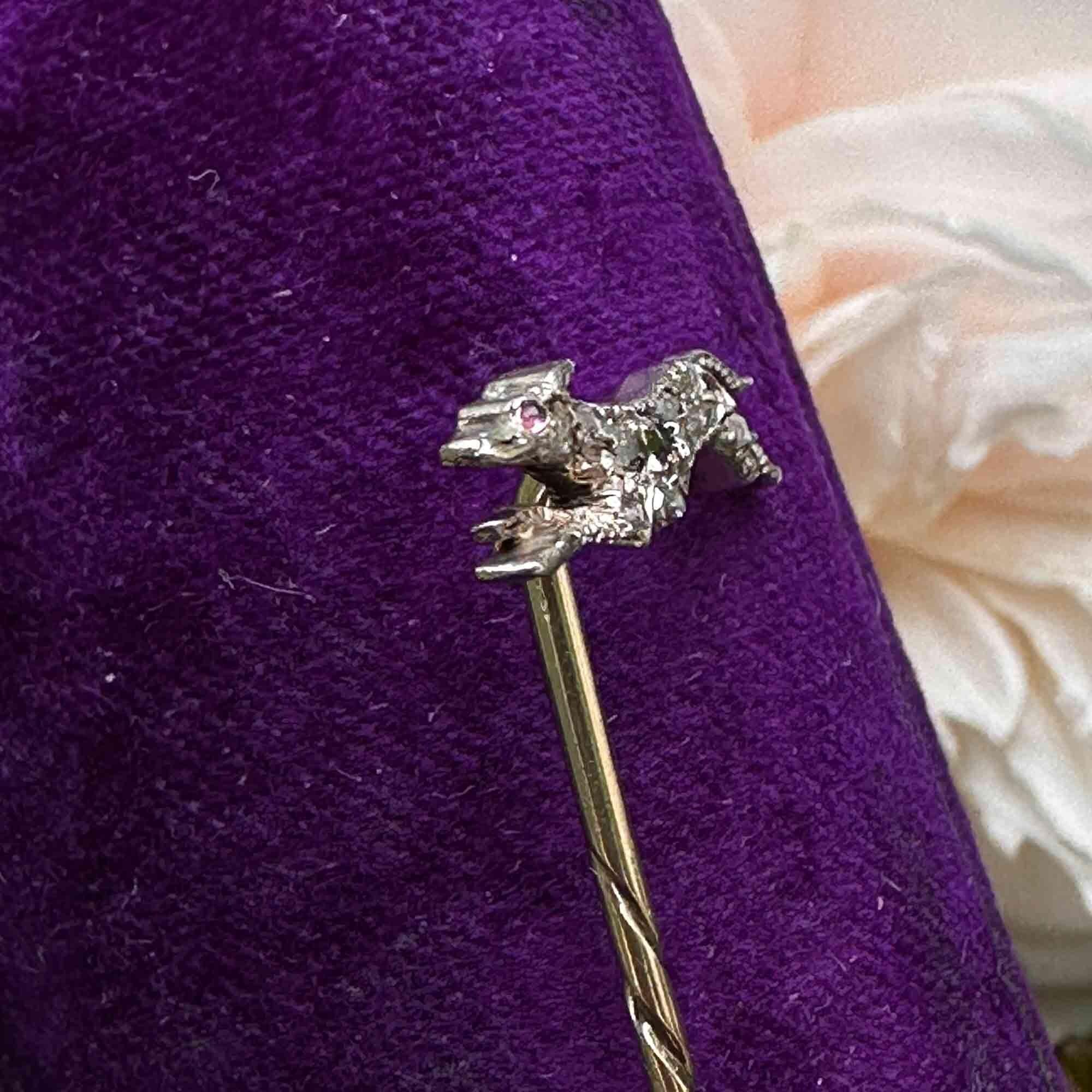 Victorian greyhound stick pin mounted with diamonds and a ruby eye, in 15ct rose gold and presented in a purple velvet antique box