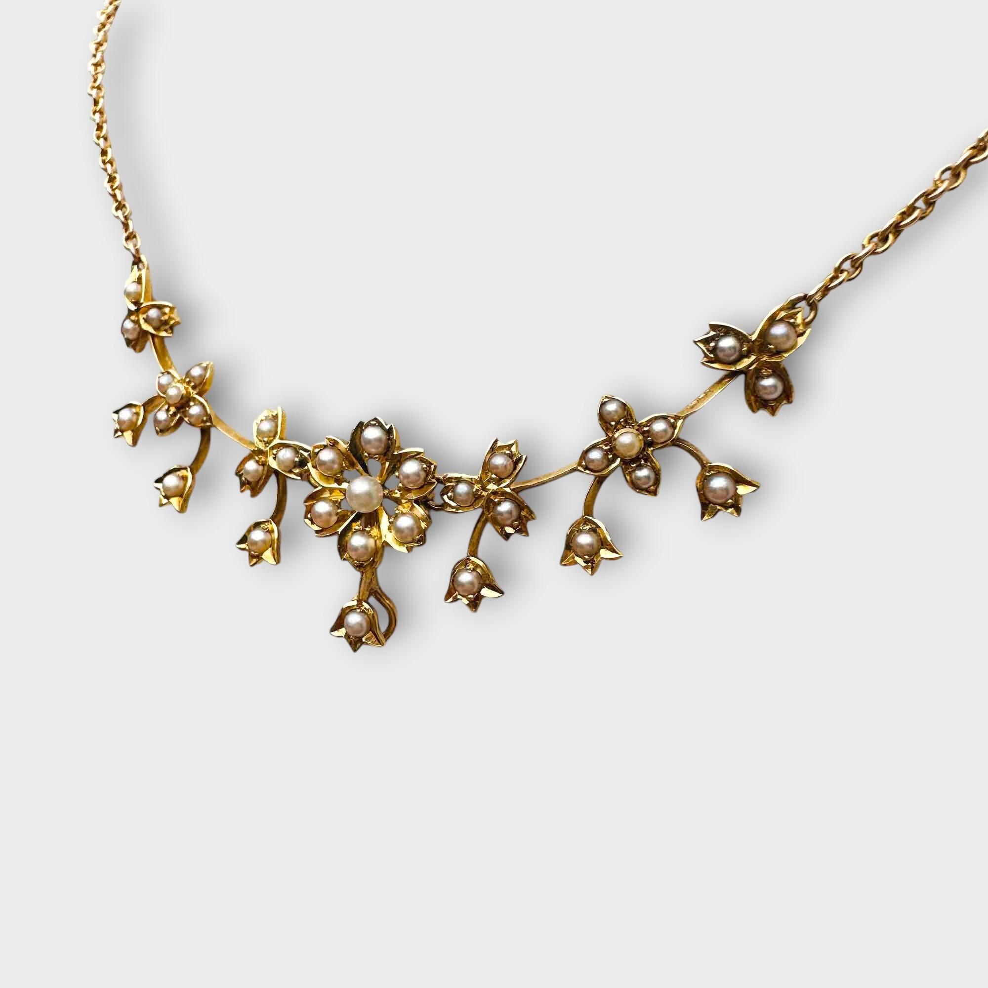 15ct gold Art Nouveau necklace with pearl studded, central floral articulated piece on a chain
