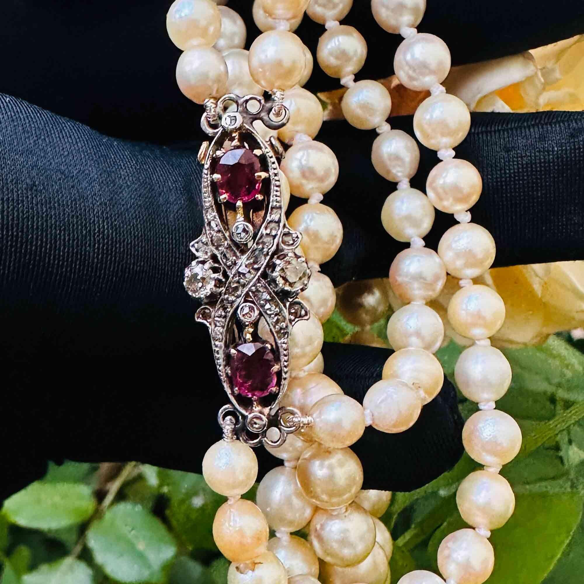 Art Deco cultured saltwater double strand pearl necklace on ruby and diamond studded 18ct gold clasp
