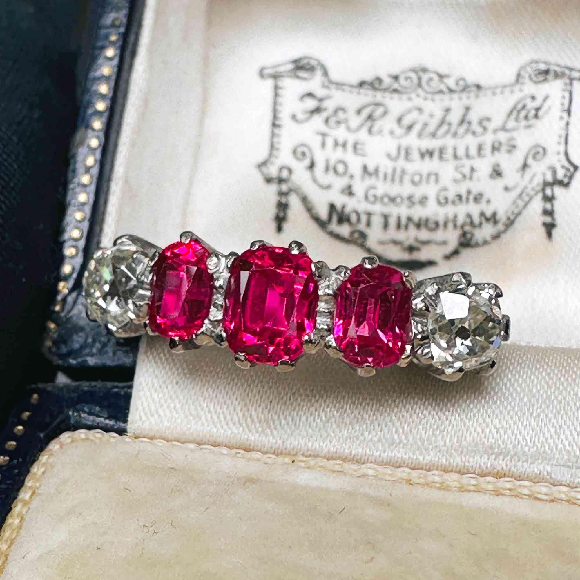 vintage ring with three pink spinel gemstones flanked by two, old-mine cut diamonds all set in 18ct white gold